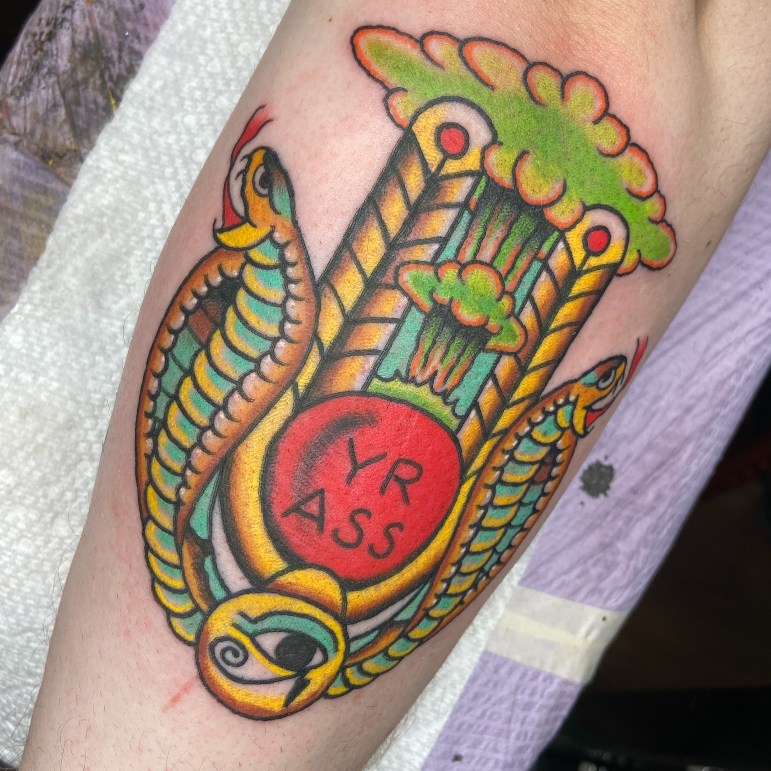 Snake and peony American traditional tattoo on the forearm by nicholas mcevoy, Boston, Massachusetts