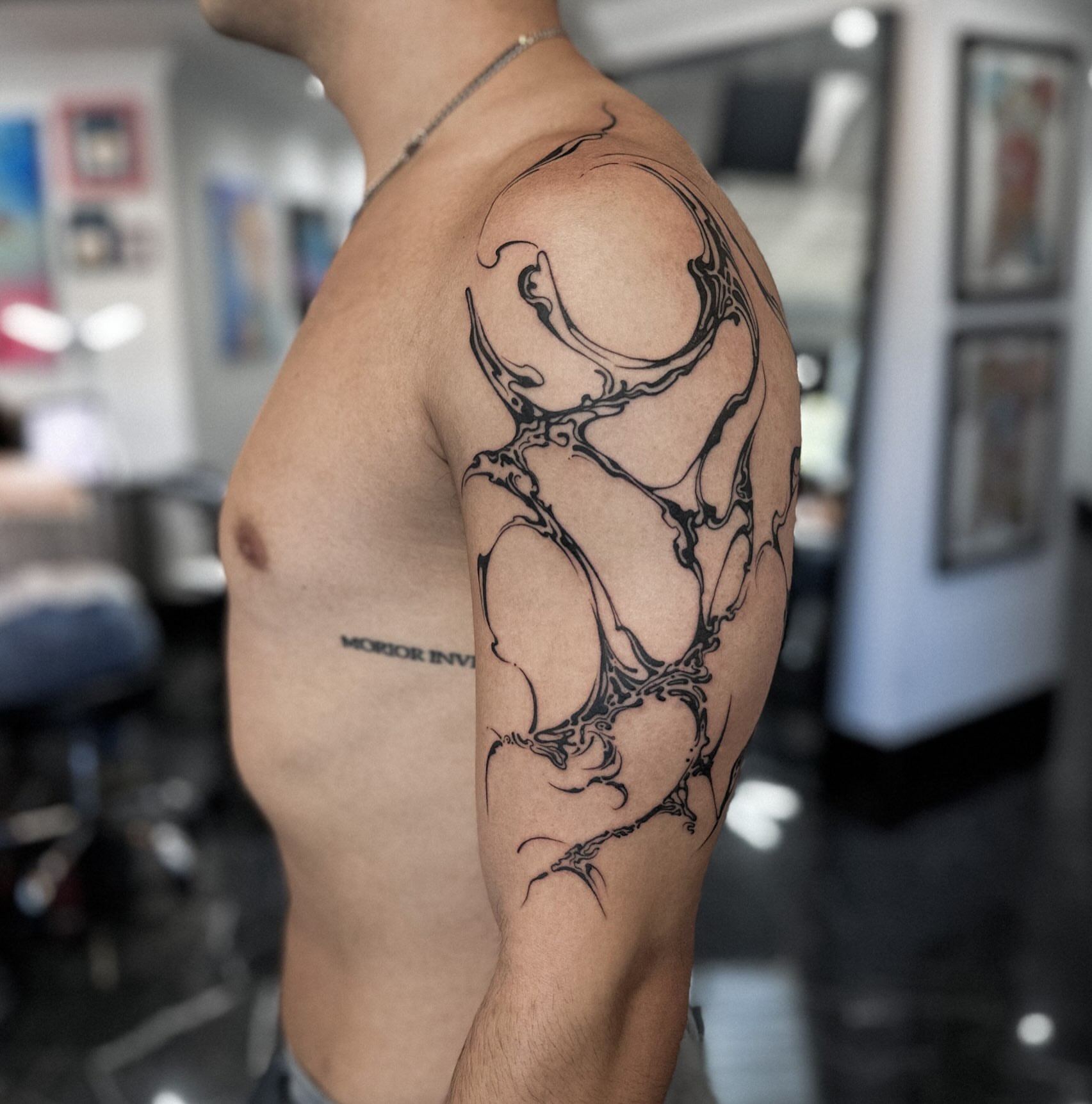 Antlers black and grey tattoo on the shoulder by Elvira Savchuk