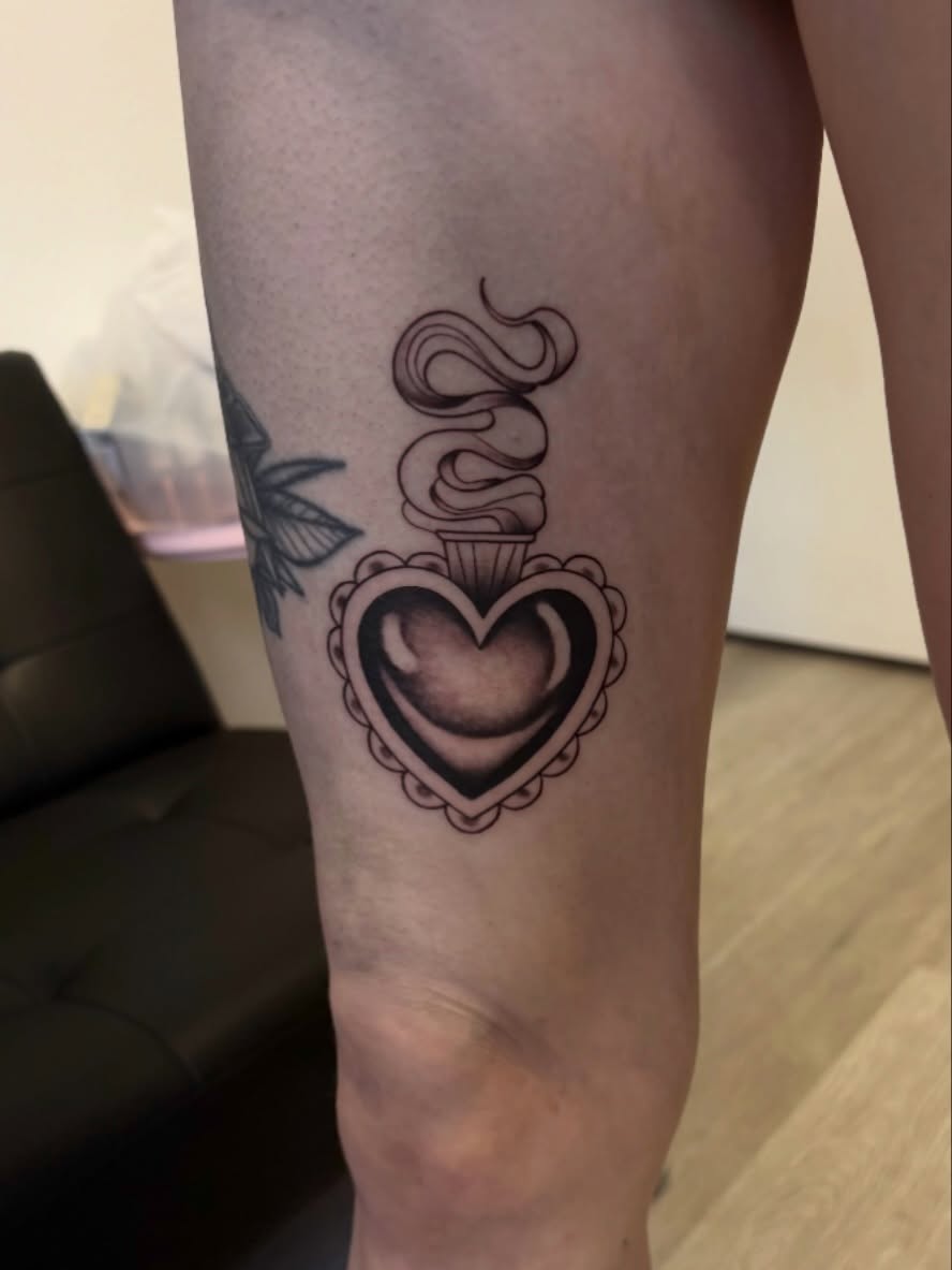Heart with snake black and grey tattoo on the thigh by Elixabeth