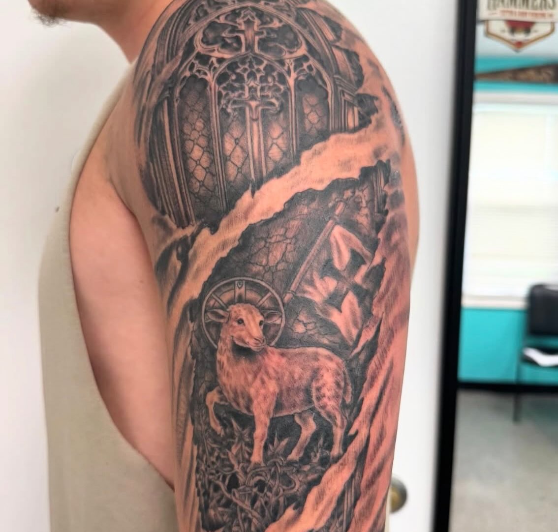 Lamb and cross realism tattoo on the forearm by Brazun Locker Poloschan