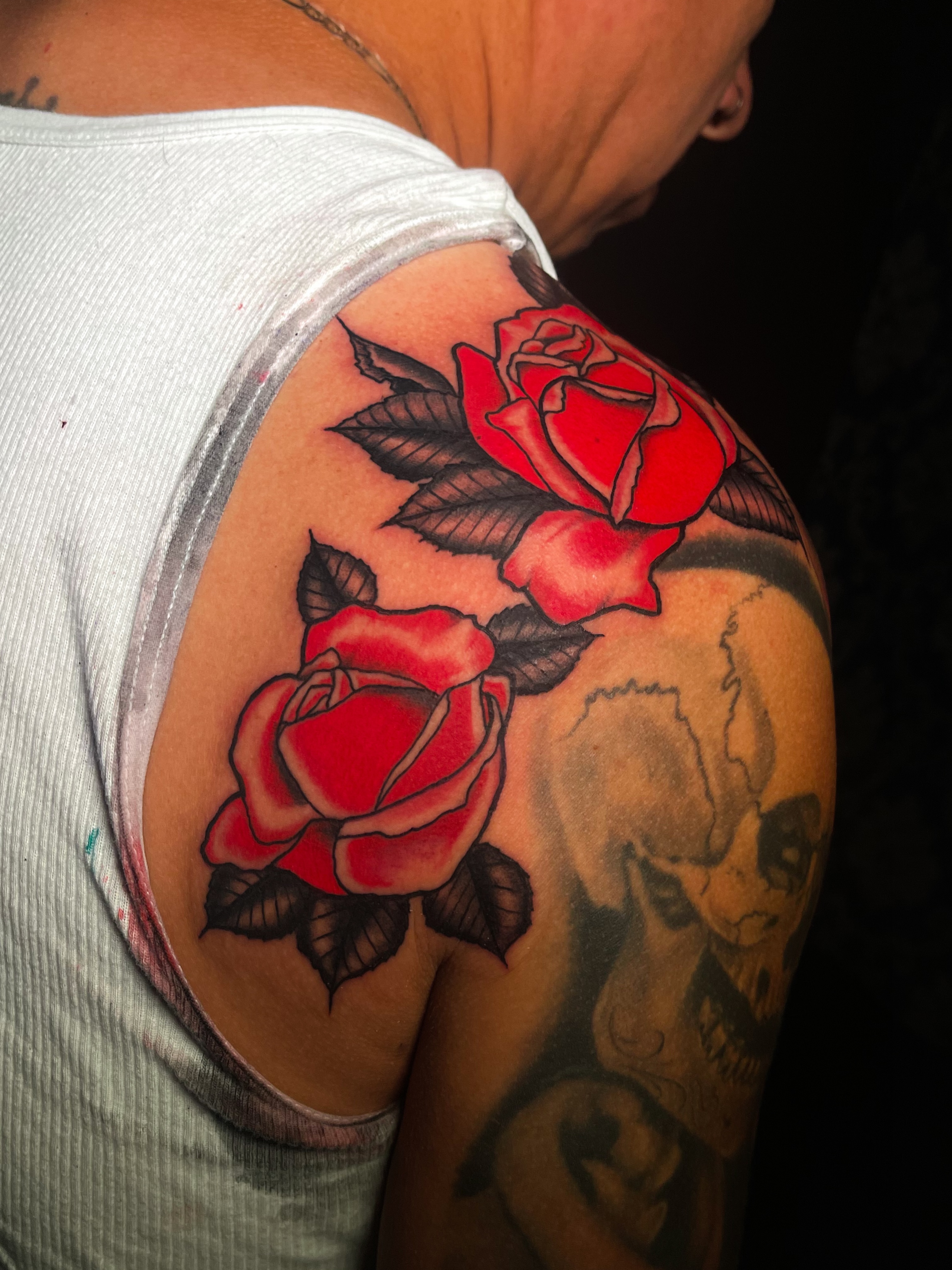 Red roses American traditional tattoo on the shoulder by Miguel Henrik