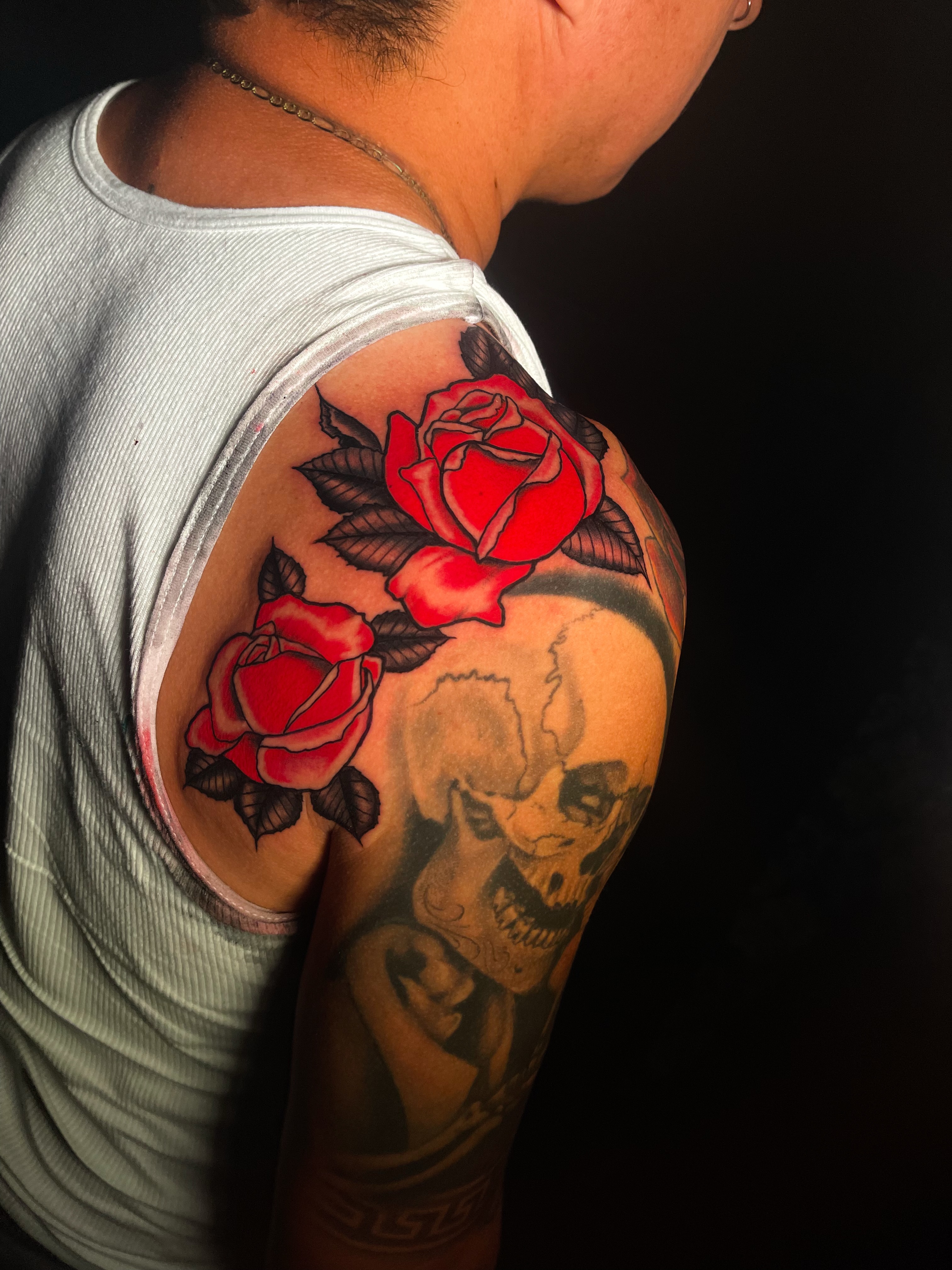 Roses and skull realism tattoo on the shoulder by Miguel Henrik