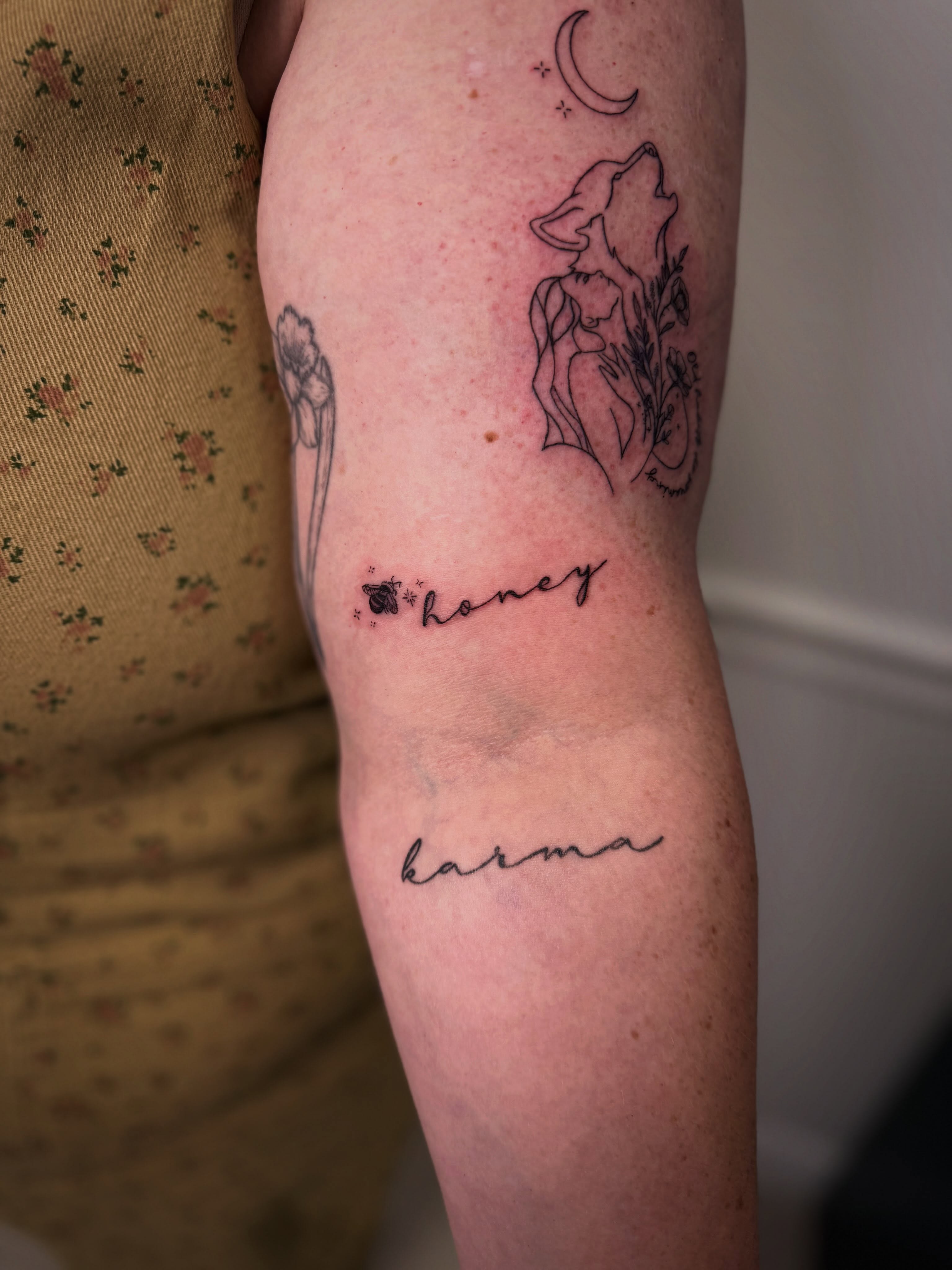 Wolf howling at moon fine line tattoo on the forearm by Taylor Johnson