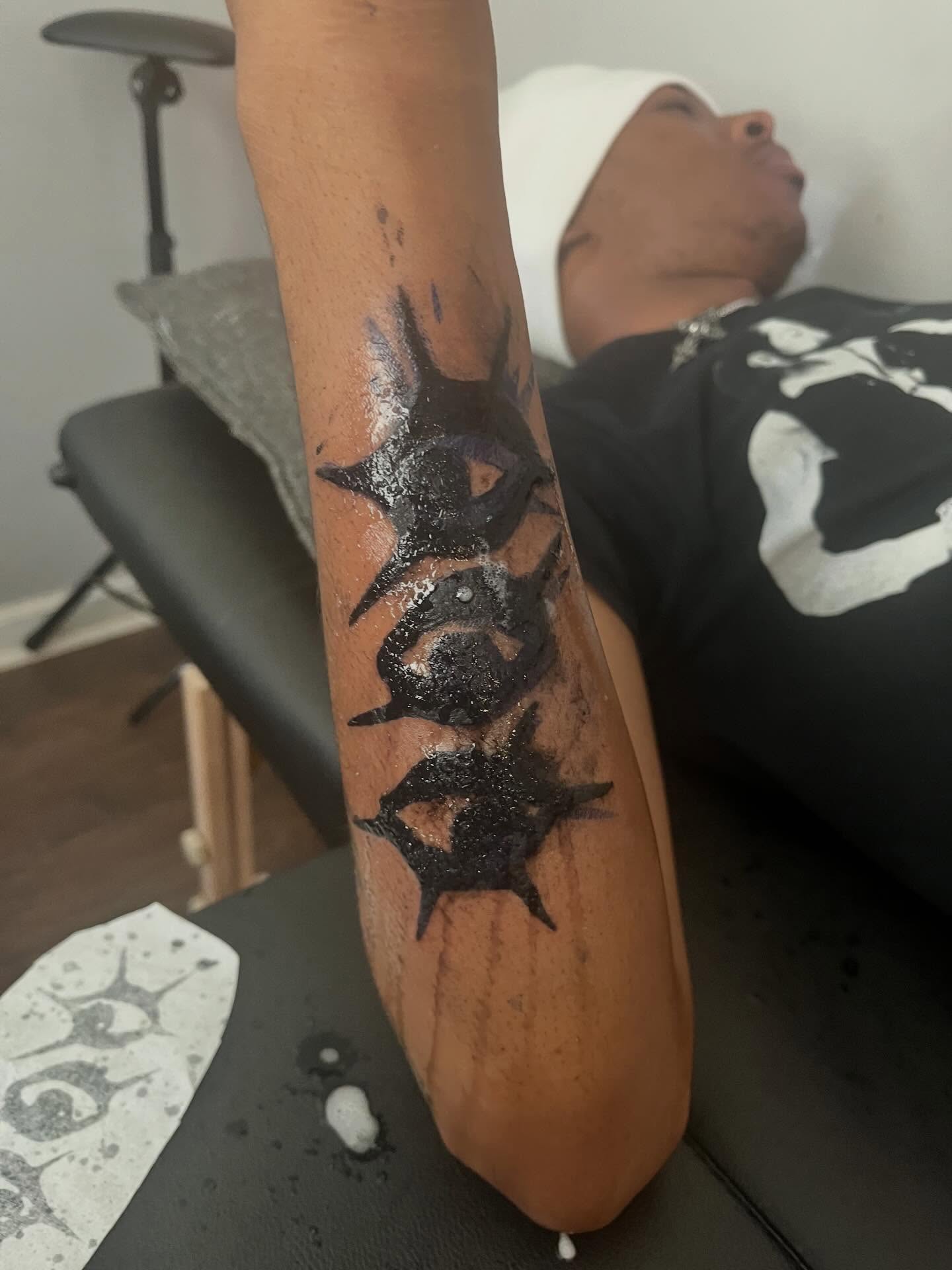 Spiky starburst black and grey tattoo on the forearm by π Westside