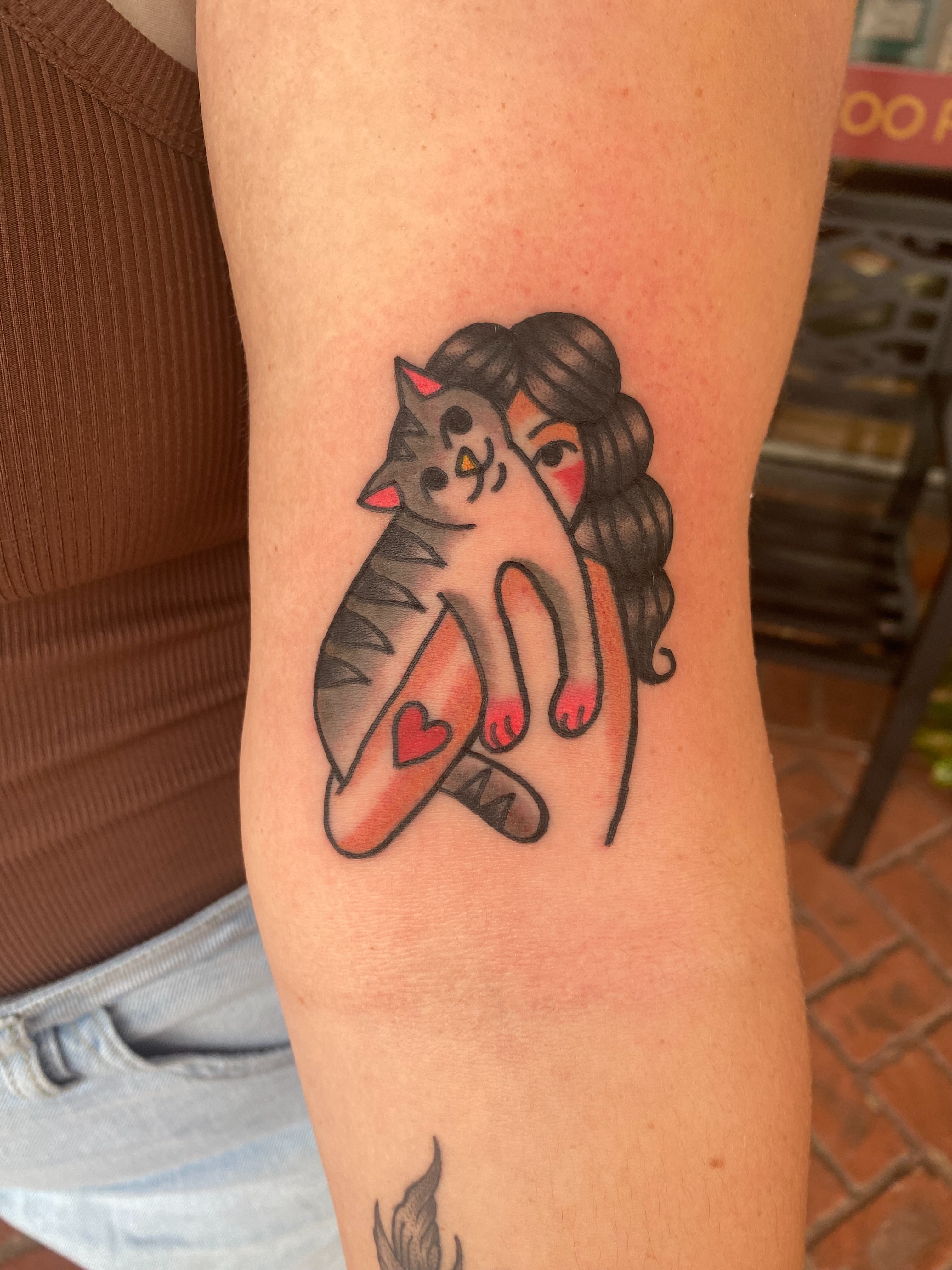 Cat hugging woman illustrative tattoo on the forearm by AARON MASTERS - Tattoo Artist