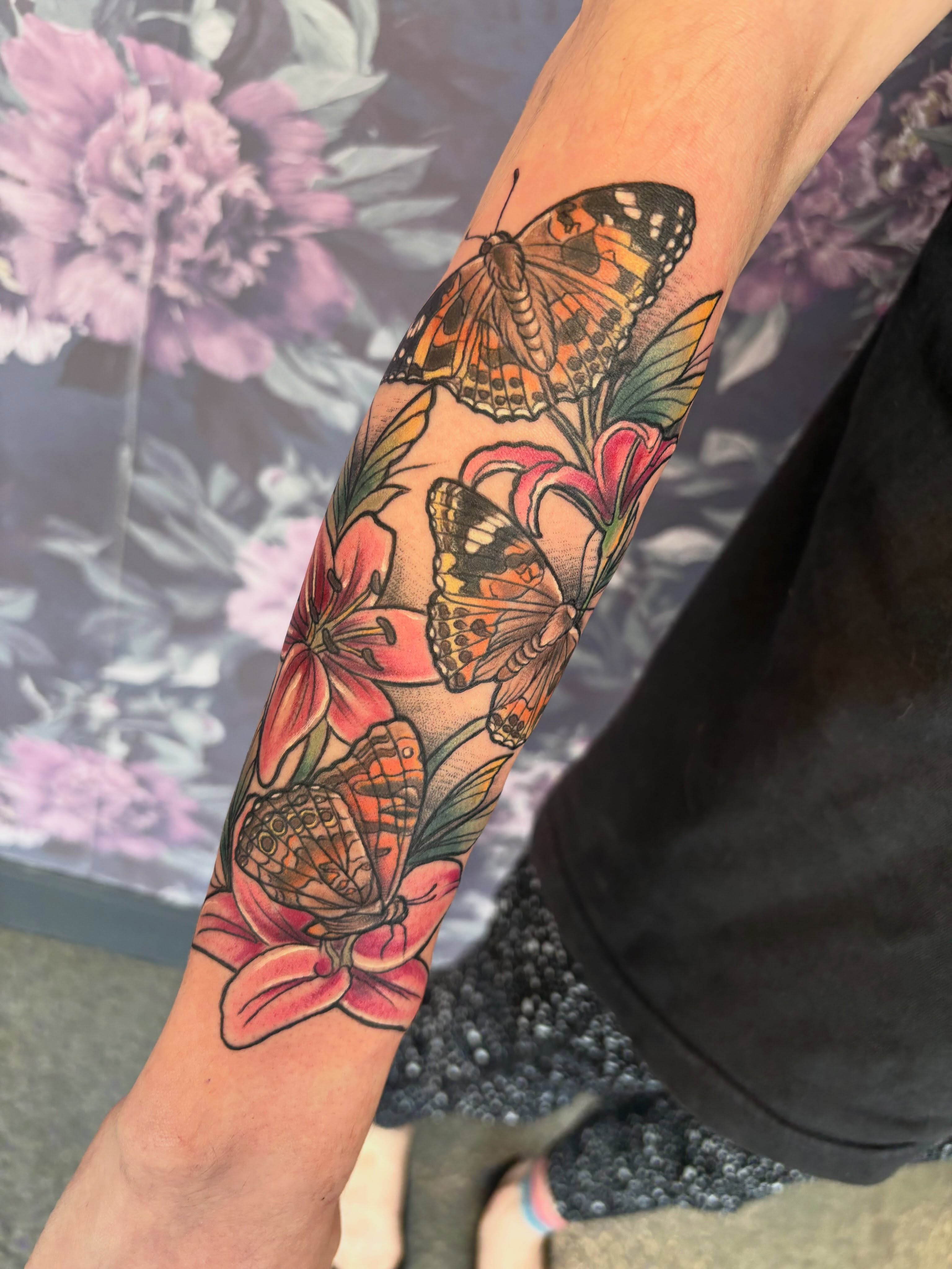 Butterflies and flowers realism tattoo on the forearm by Bre Alex