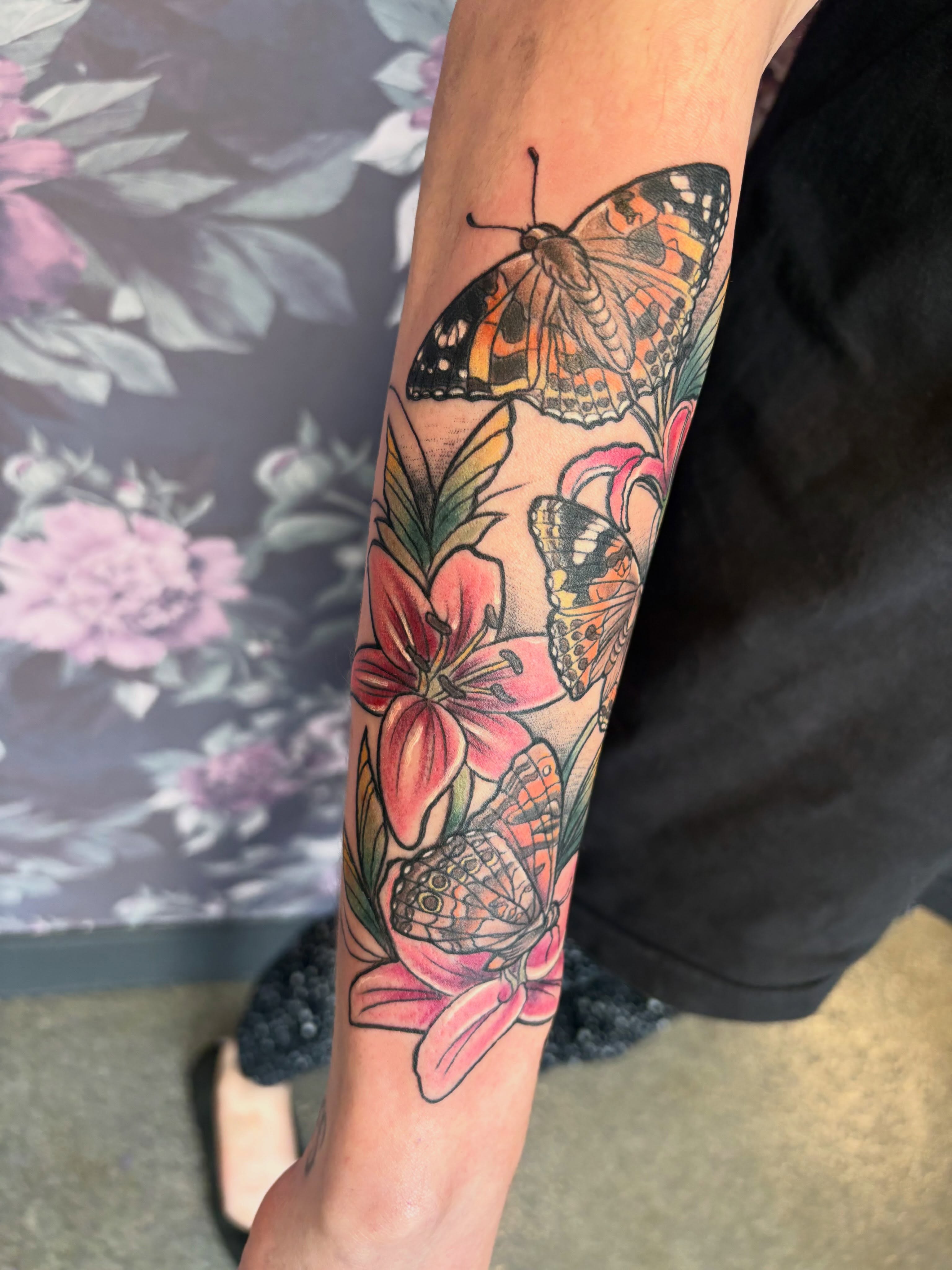 Butterflies and flowers new school tattoo on the forearm by Bre Alex