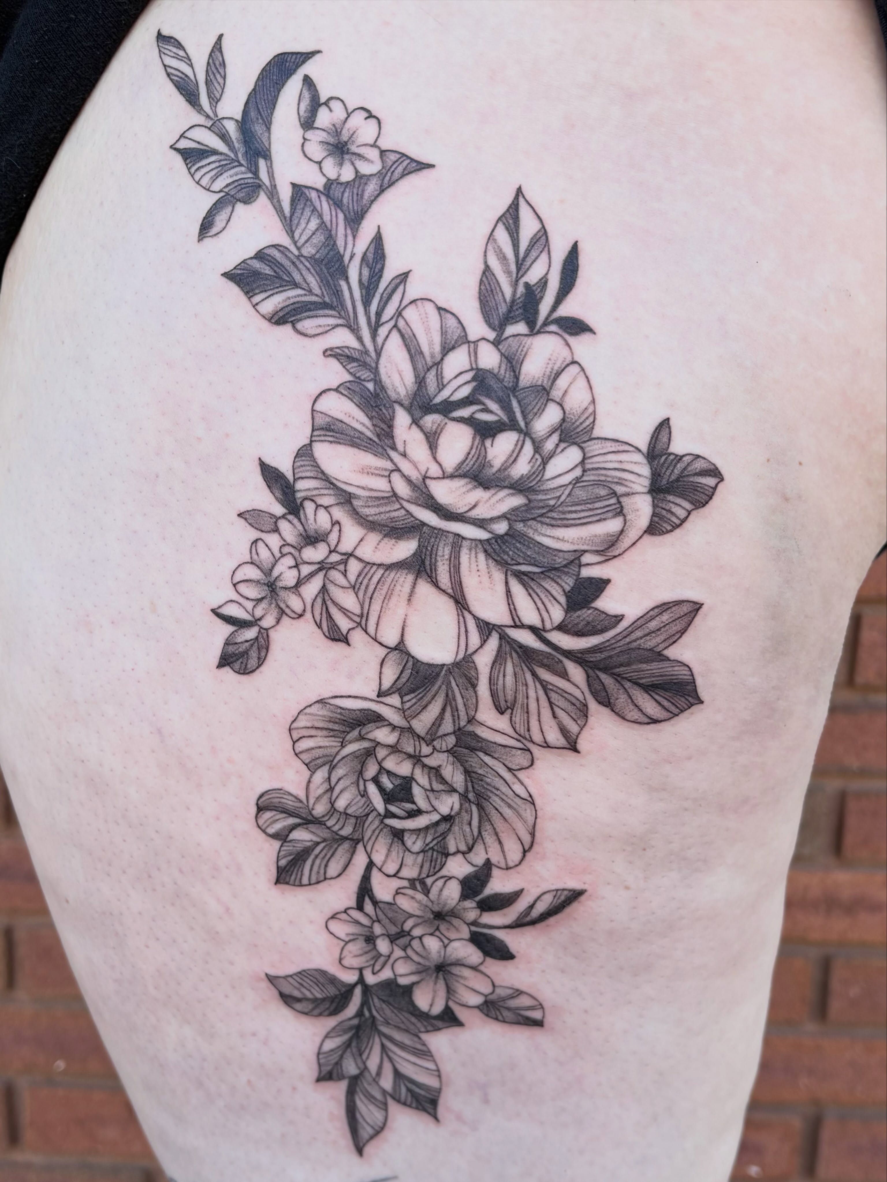 Floral bouquet realism tattoo on the thigh by Sierra Maynard
