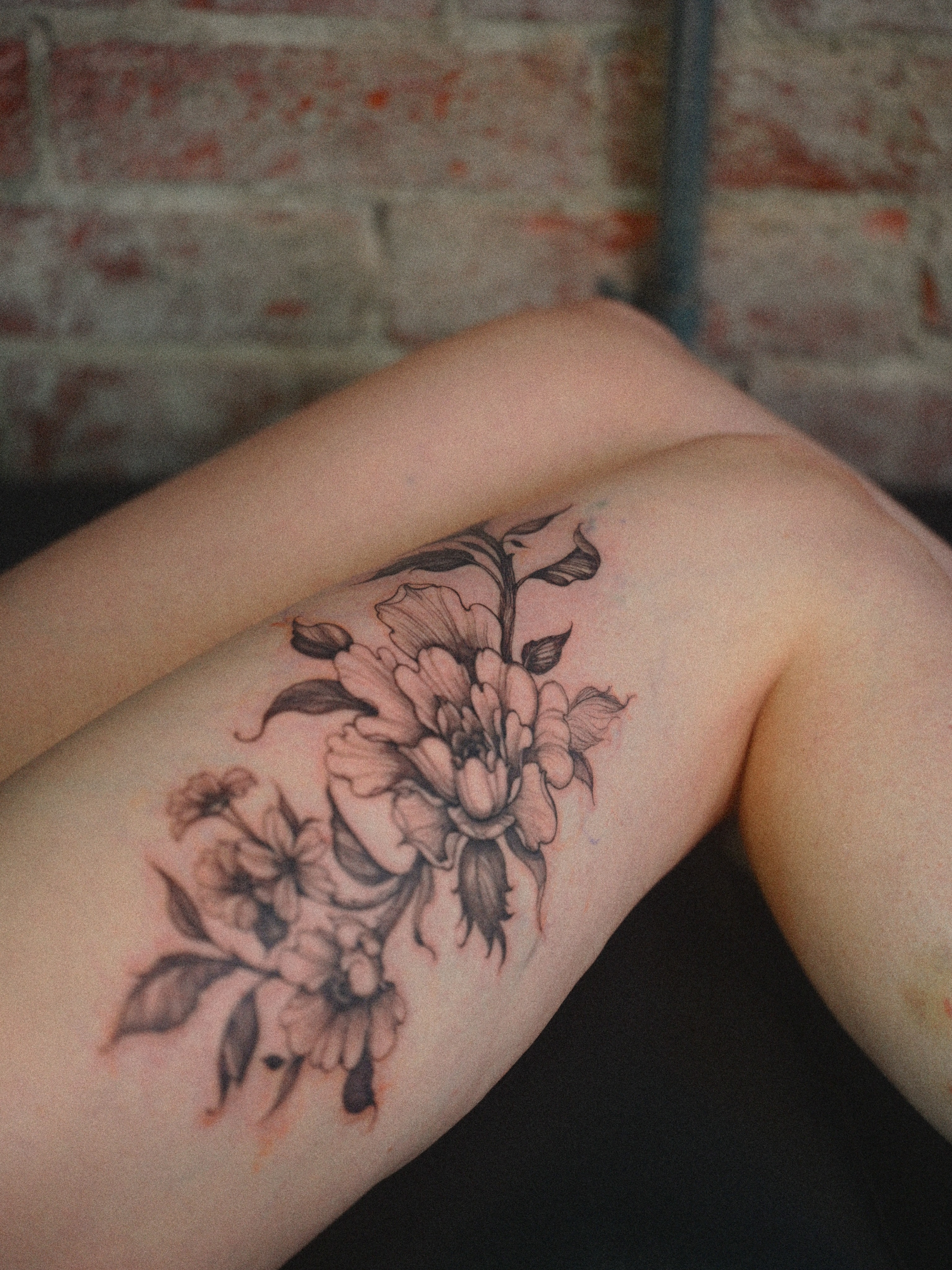 Peony flowers black and grey tattoo on the thigh by Brad Simmons