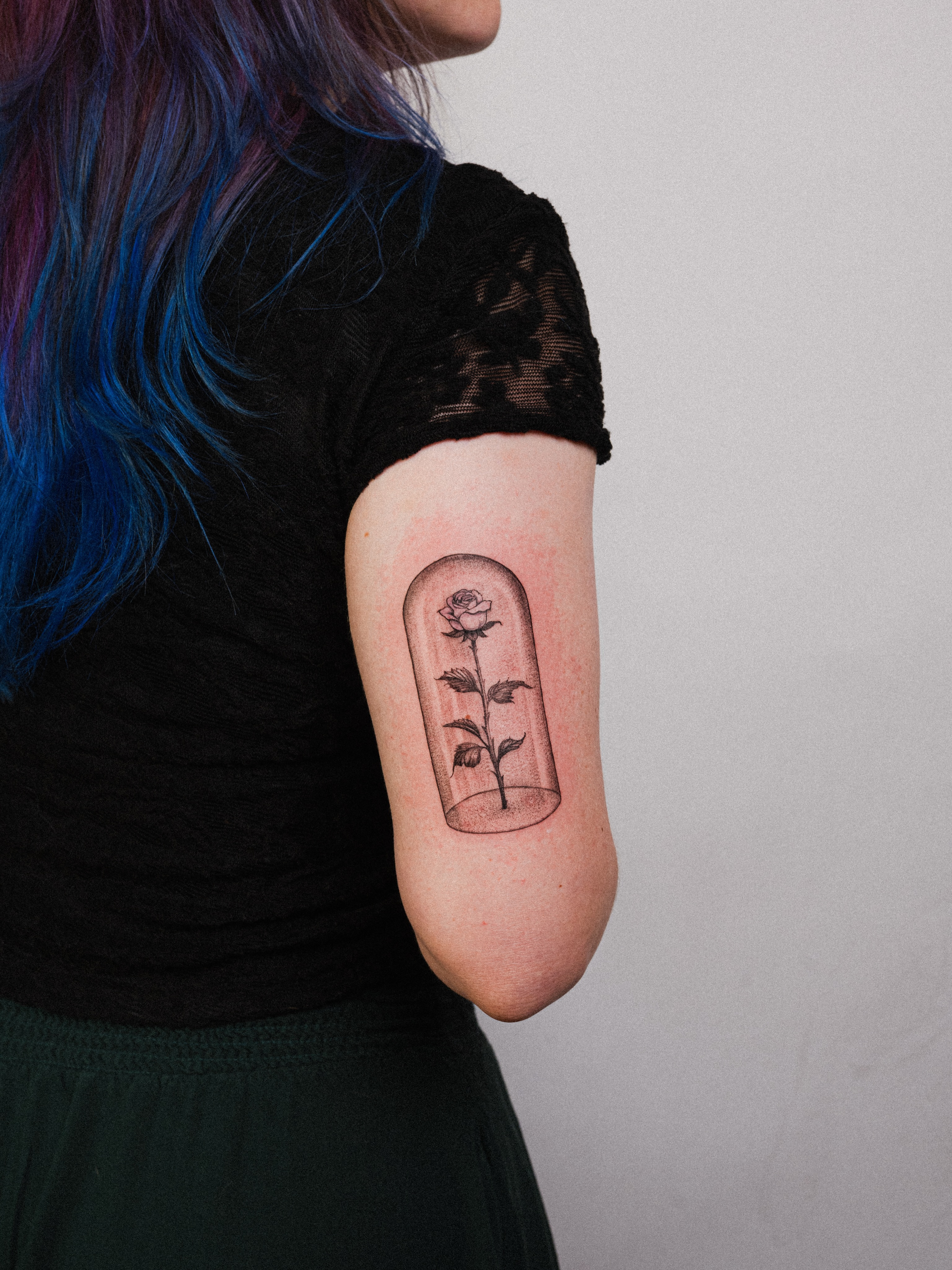 Rose in glass dome black and grey tattoo on the forearm by Brad Simmons