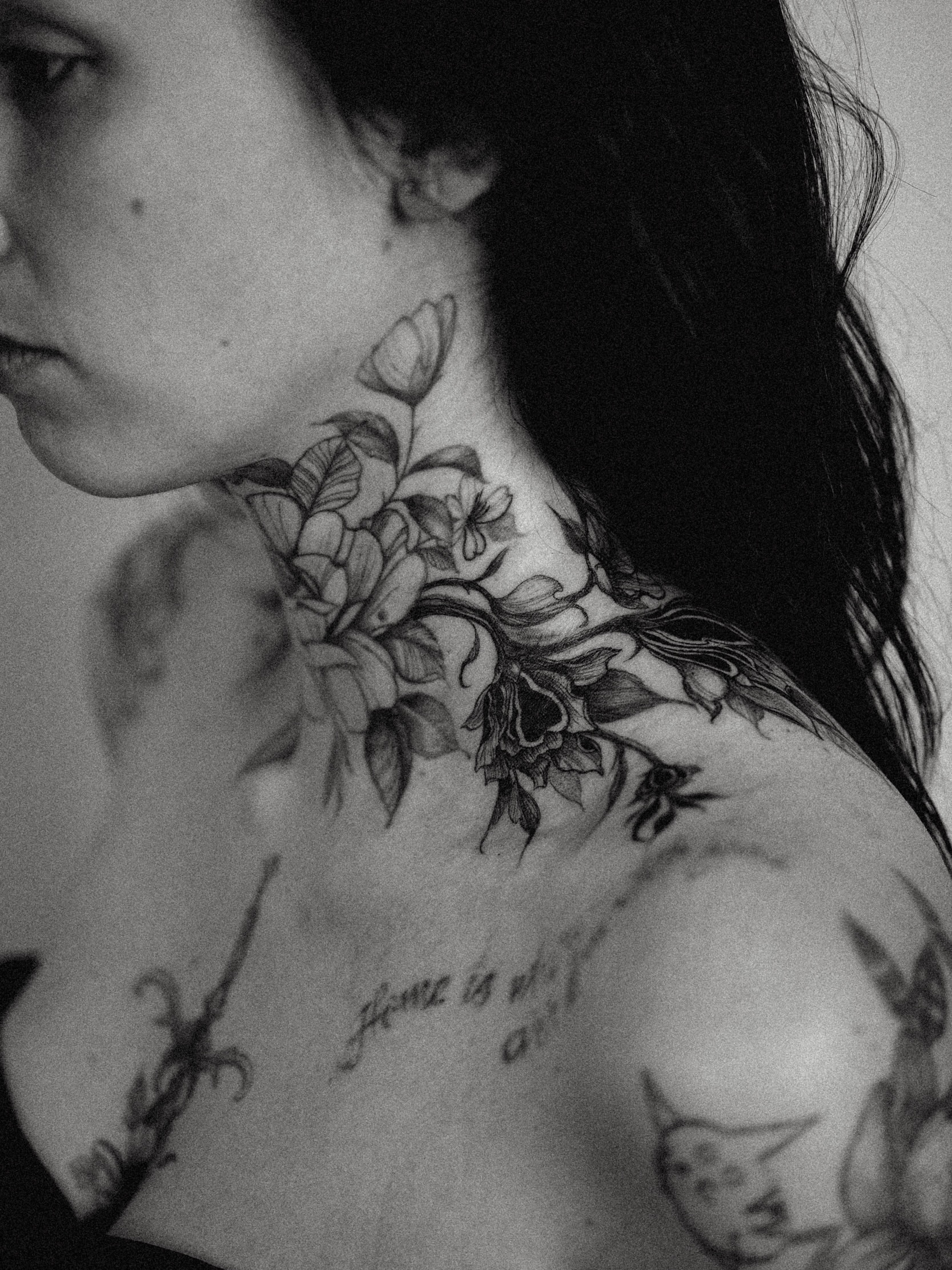 Floral arrangement black and grey tattoo on the neck by Brad Simmons