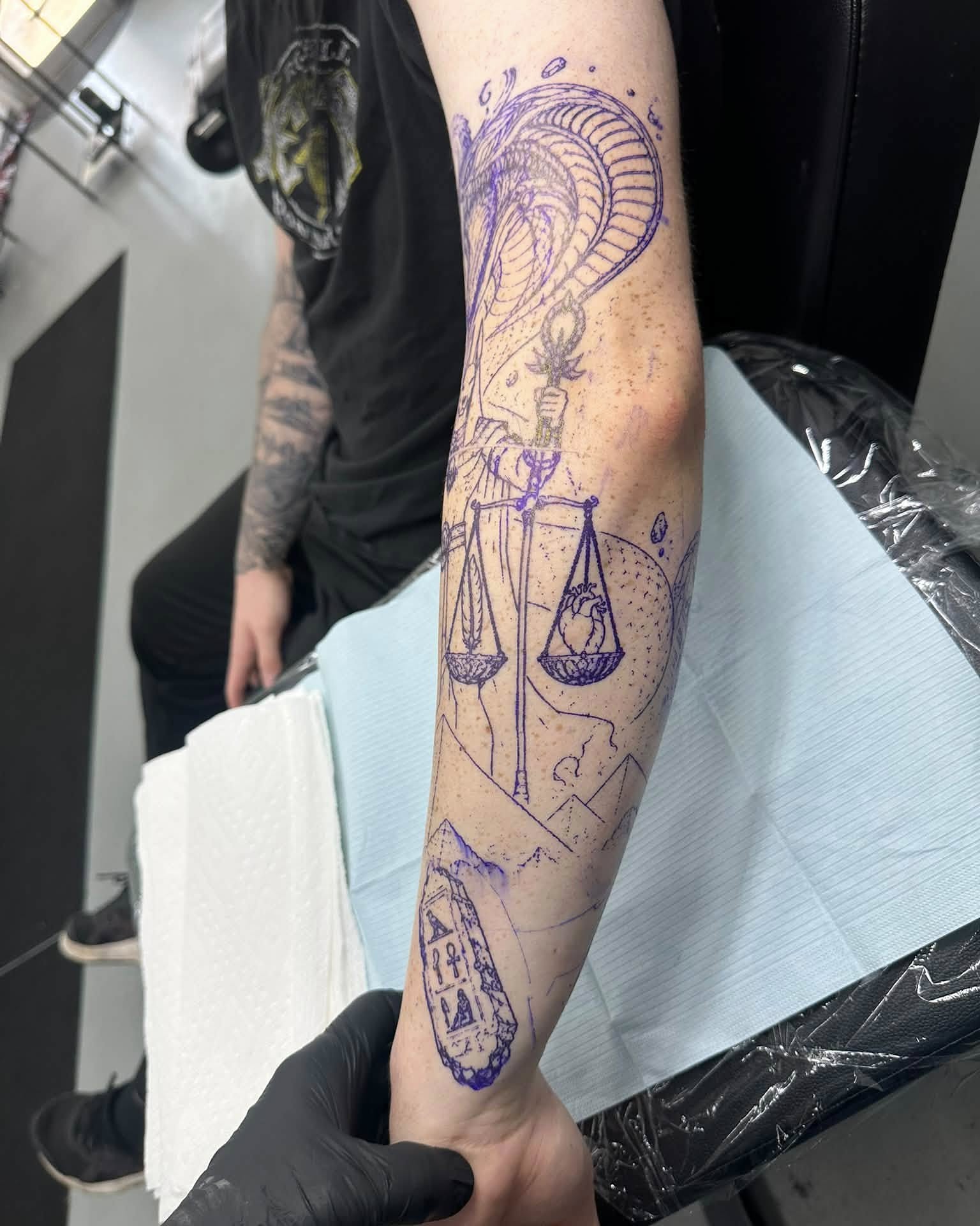 Justice scales geometric tattoo on the forearm by Brian Lambert