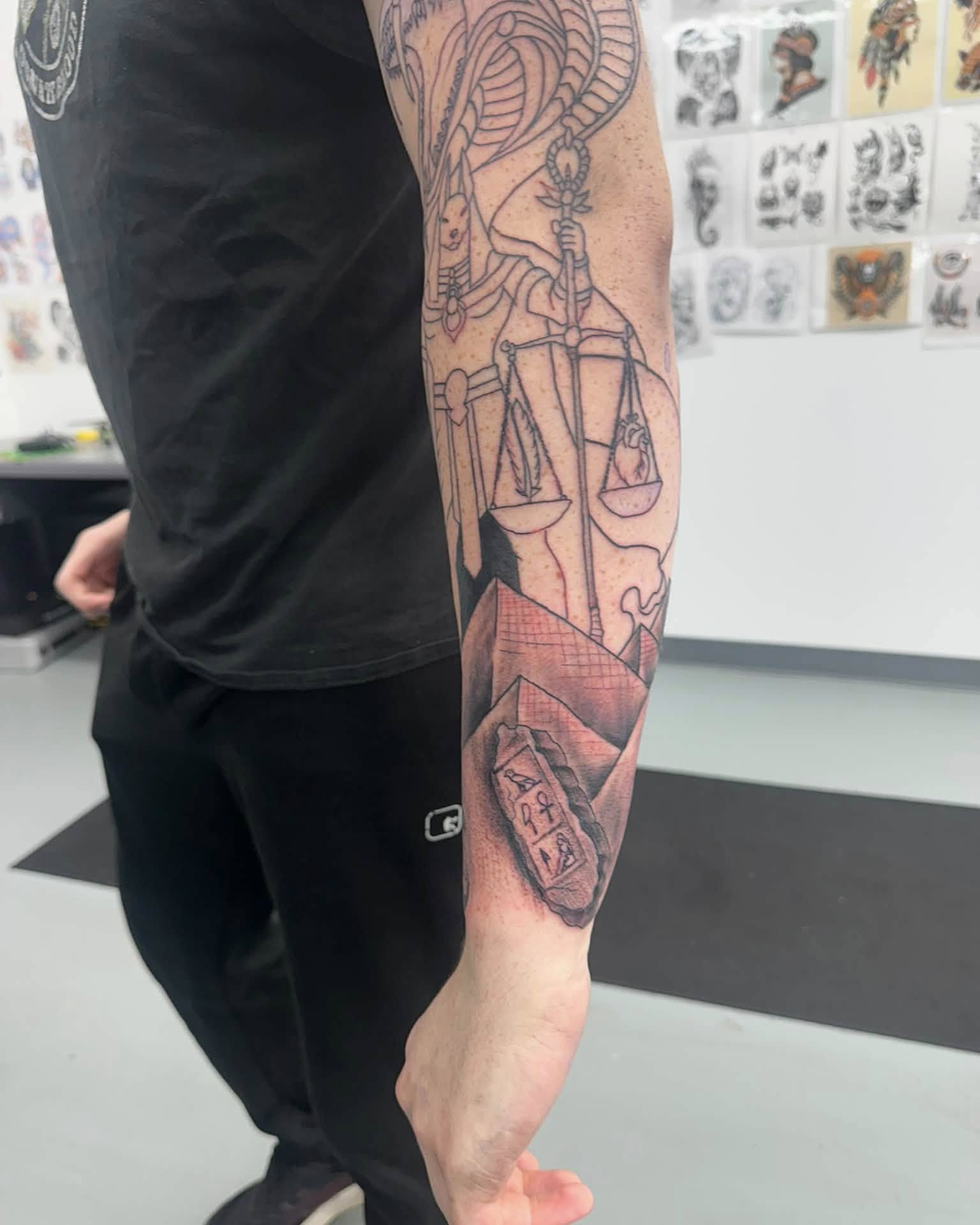 Justice scale geometric tattoo on the forearm by Brian Lambert