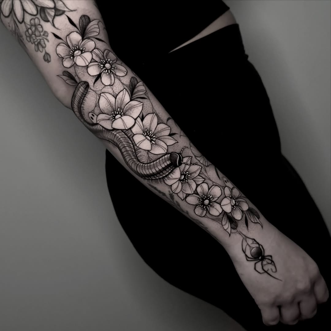 Flowers and caterpillar realism tattoo on the forearm by ɪᴠᴏɴɴᴇ