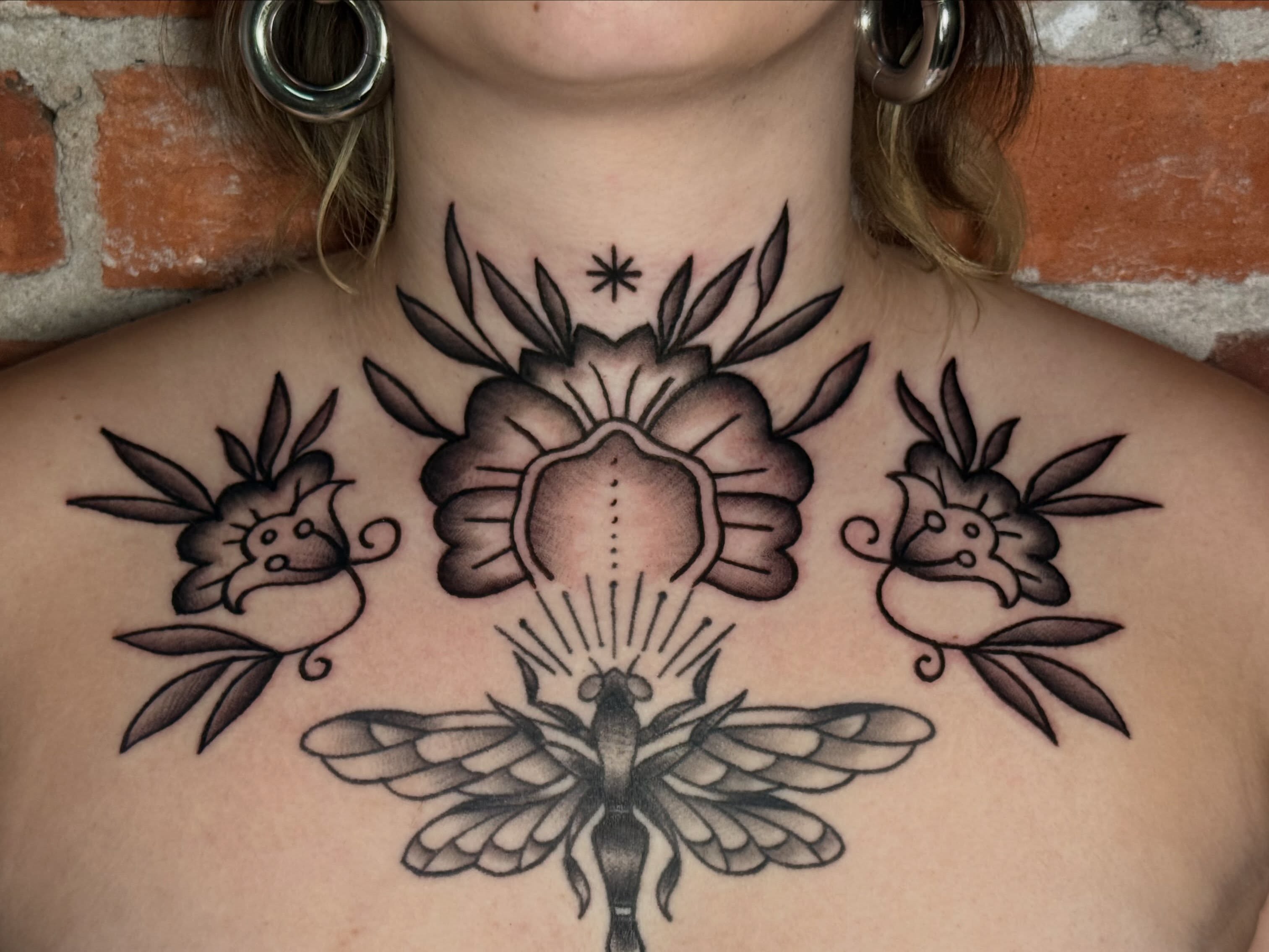 Flower and moth American traditional tattoo on the chest by CAT
