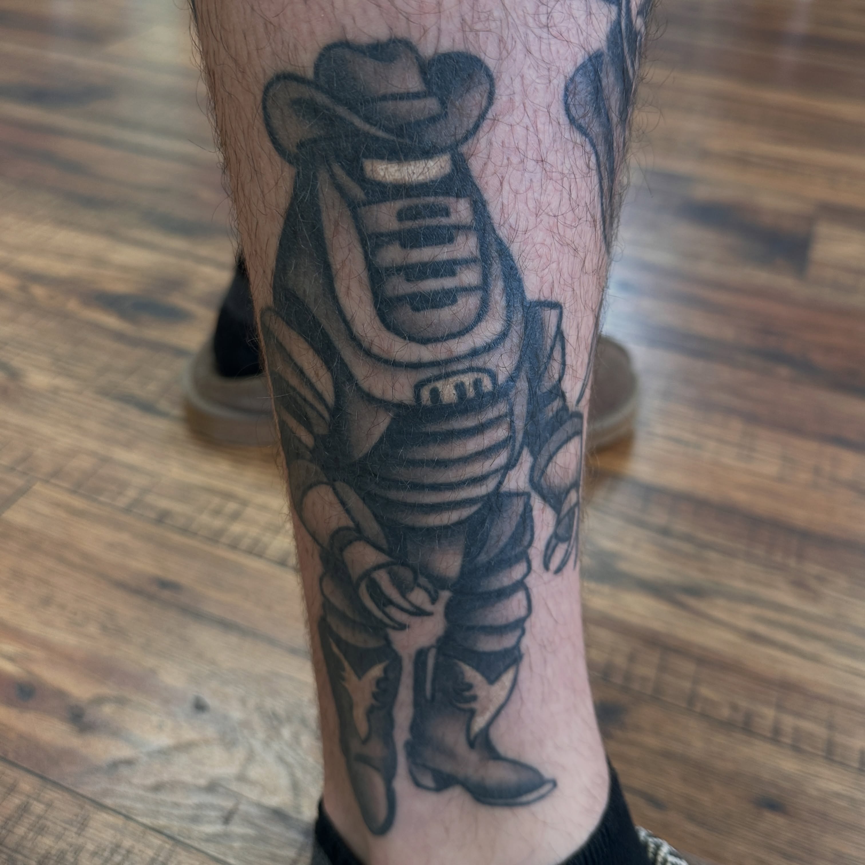 Cowboy astronaut black and grey tattoo on the forearm by Kyle Simmons