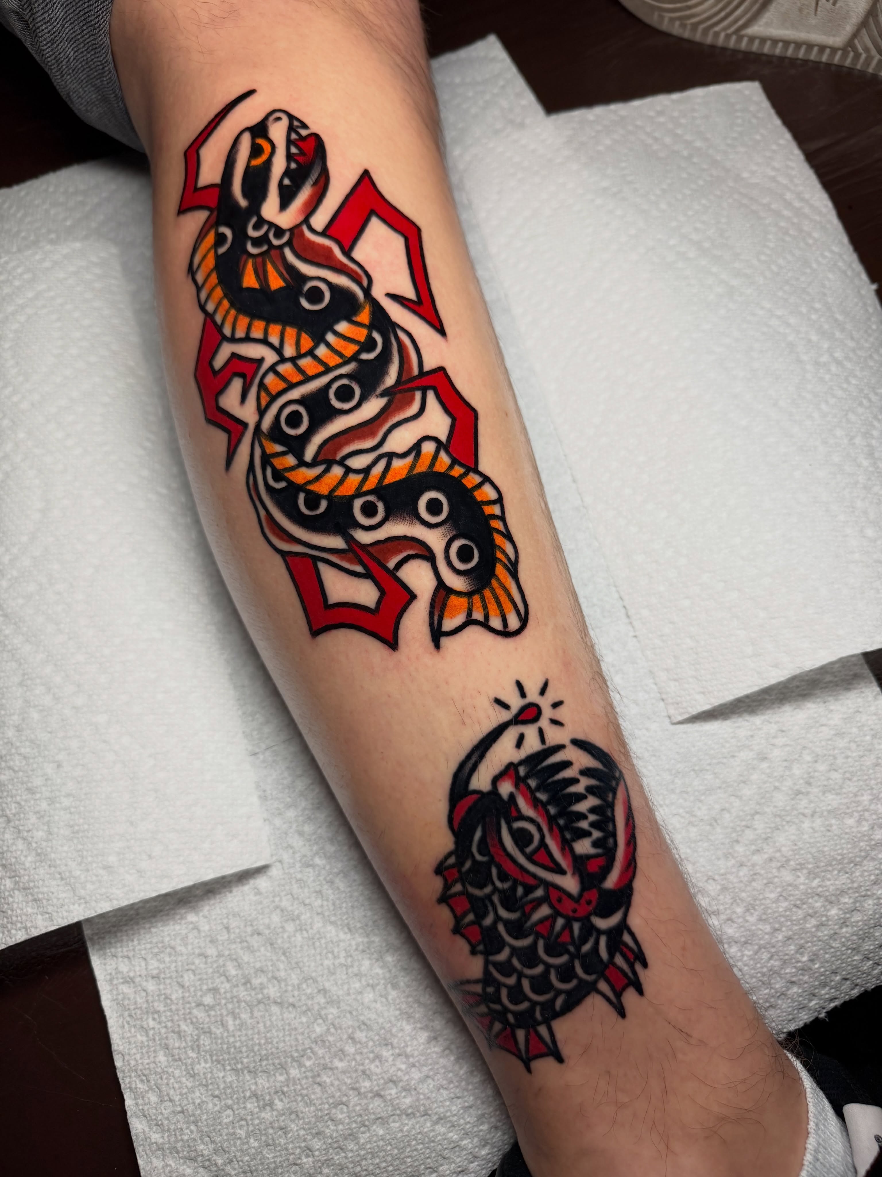 Snake and dragon American traditional tattoo on the forearm by Kyle Dean Traditional Tattoo Artist