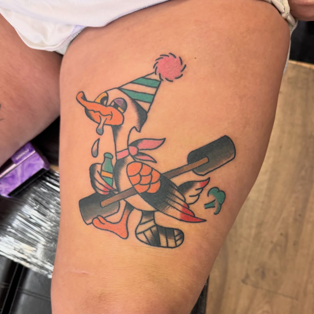Clown with oar American traditional tattoo on the thigh by Justin Chapman, Des Moines, Iowa