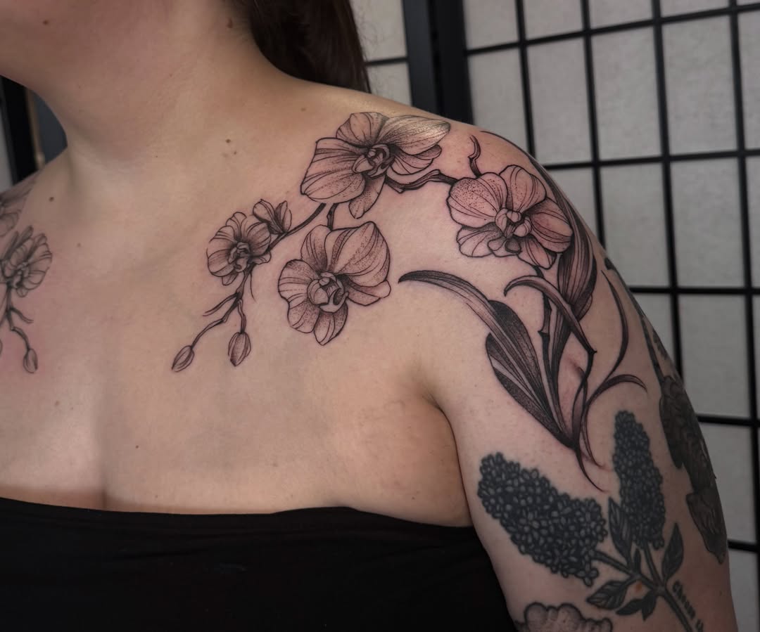 Orchids black and grey tattoo on the shoulder by Lauren Peltz