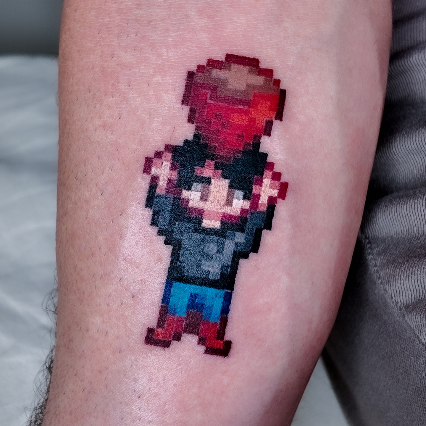 Pixel art character tattoo on the forearm by m r p i x e l ๐ธ๐ฌ