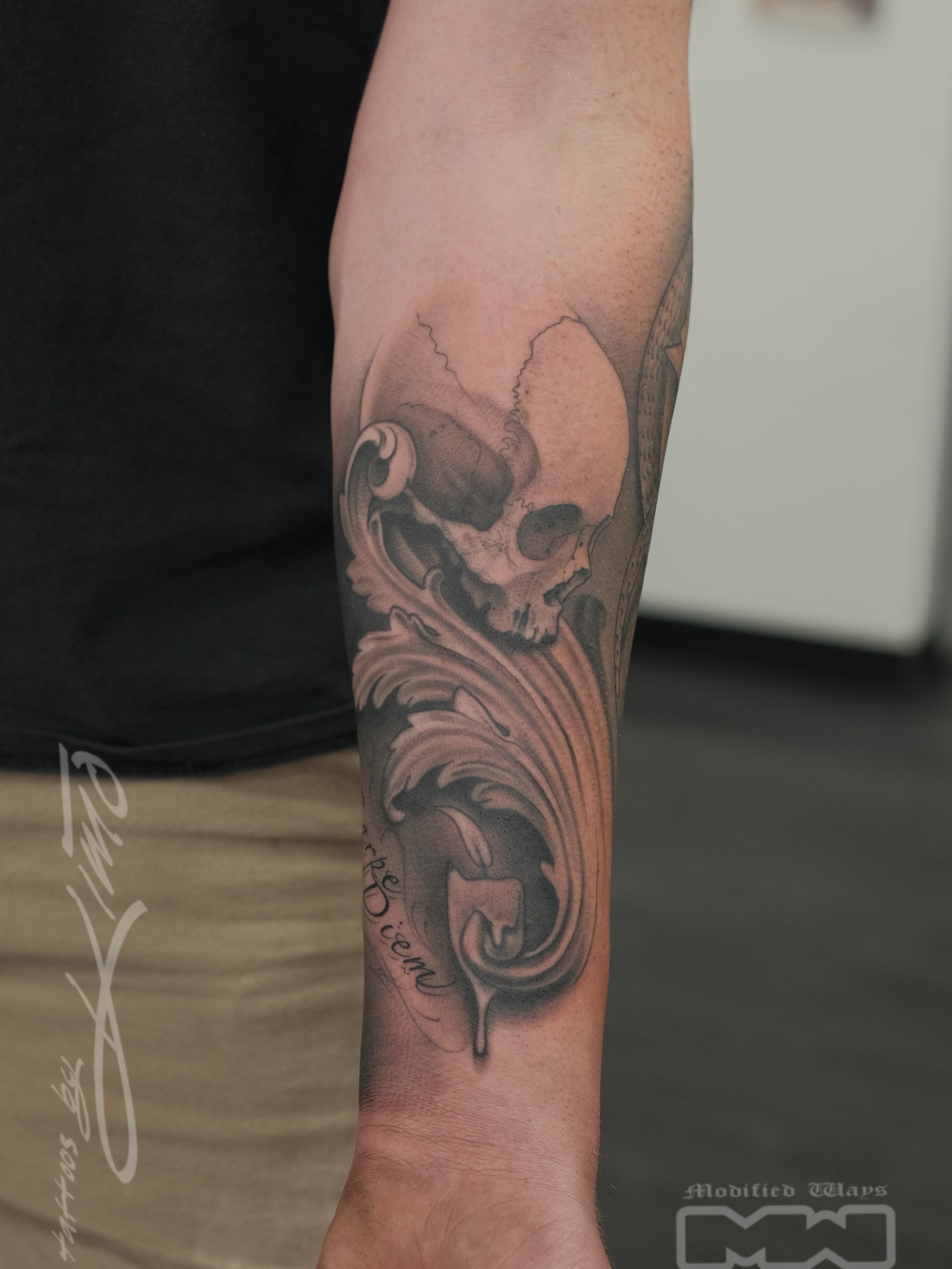 Skull and wave realism tattoo on the forearm by Kansas City tattoo artist