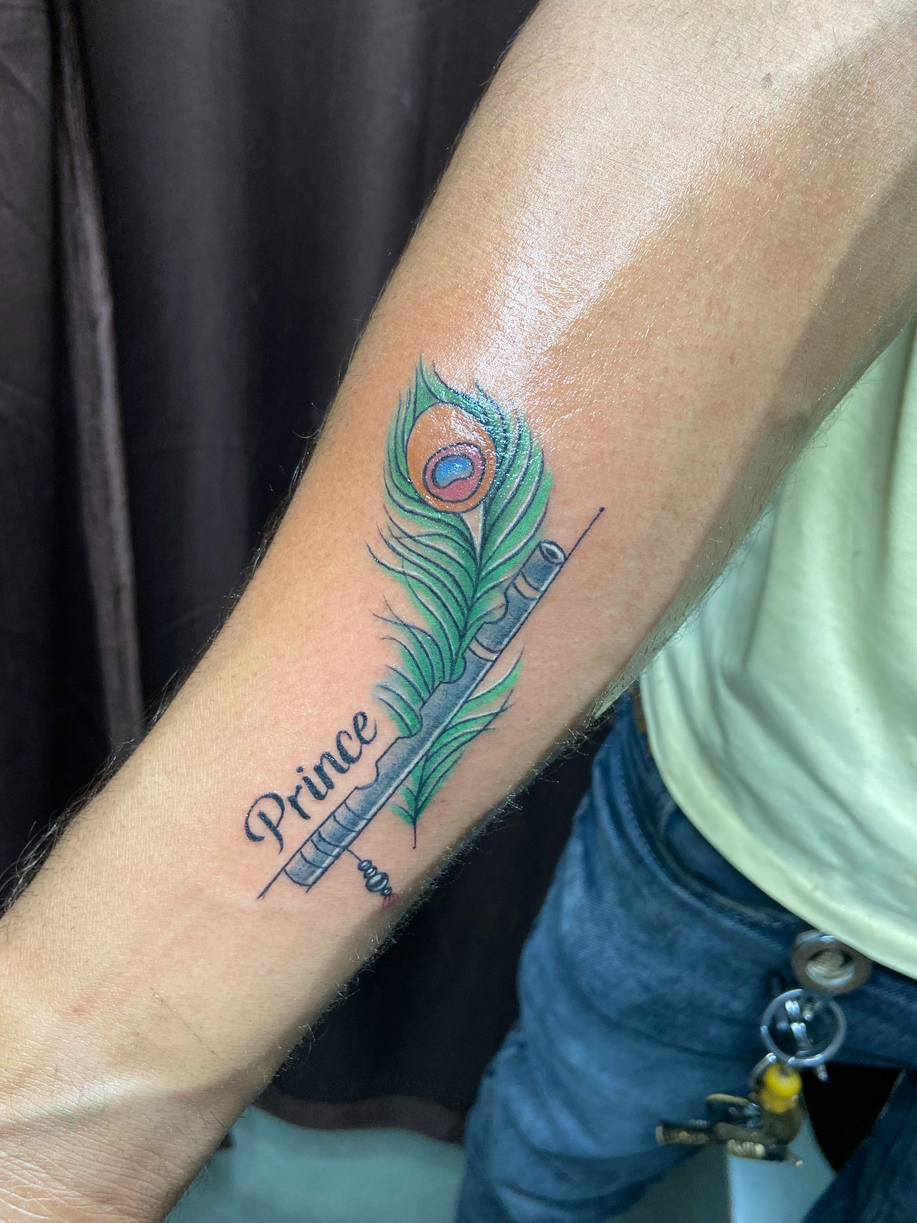 Peacock feather new school tattoo on the forearm by VR tattoo Studio