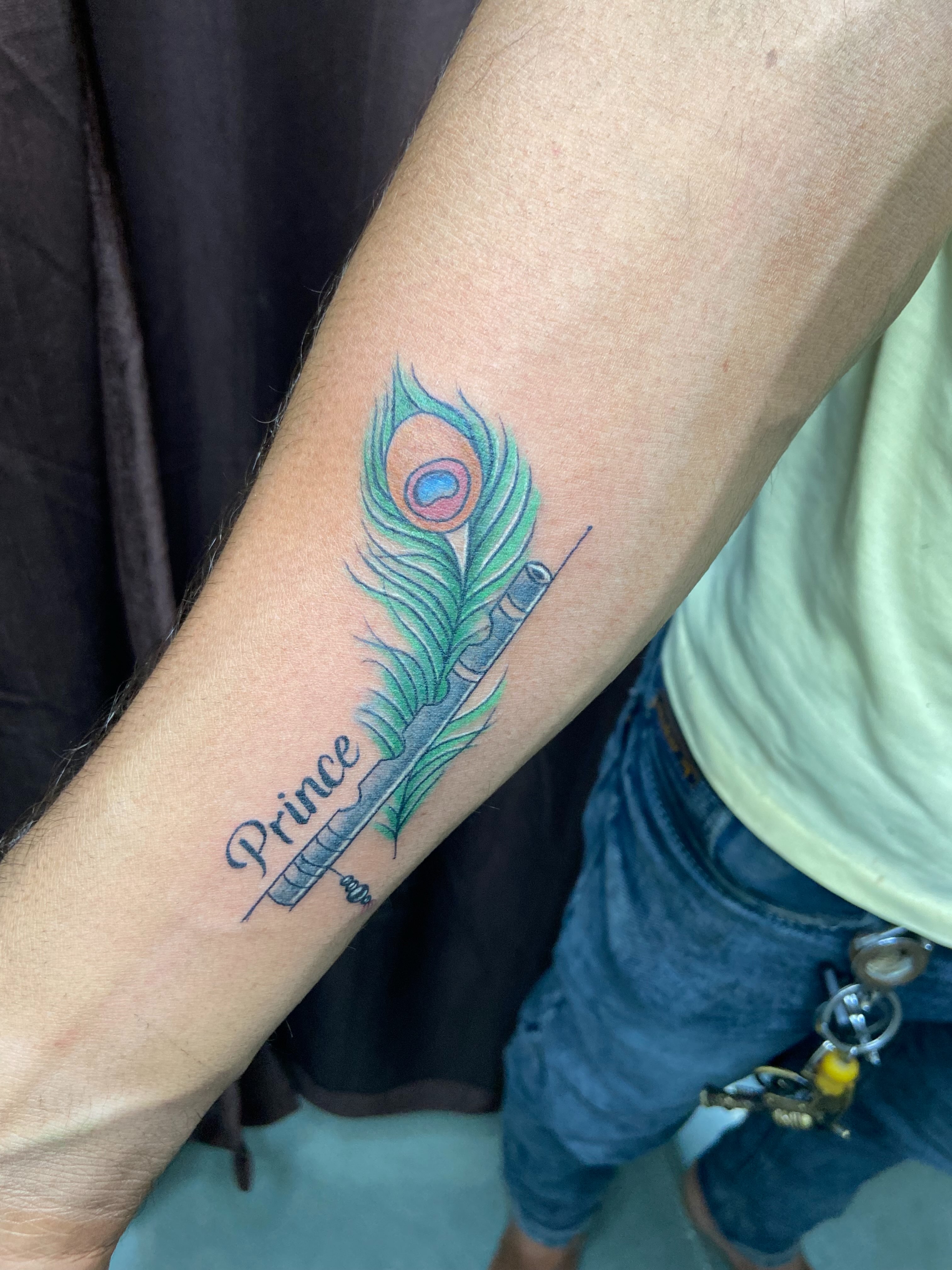 Peacock feather realism tattoo on the forearm by VR tattoo Studio