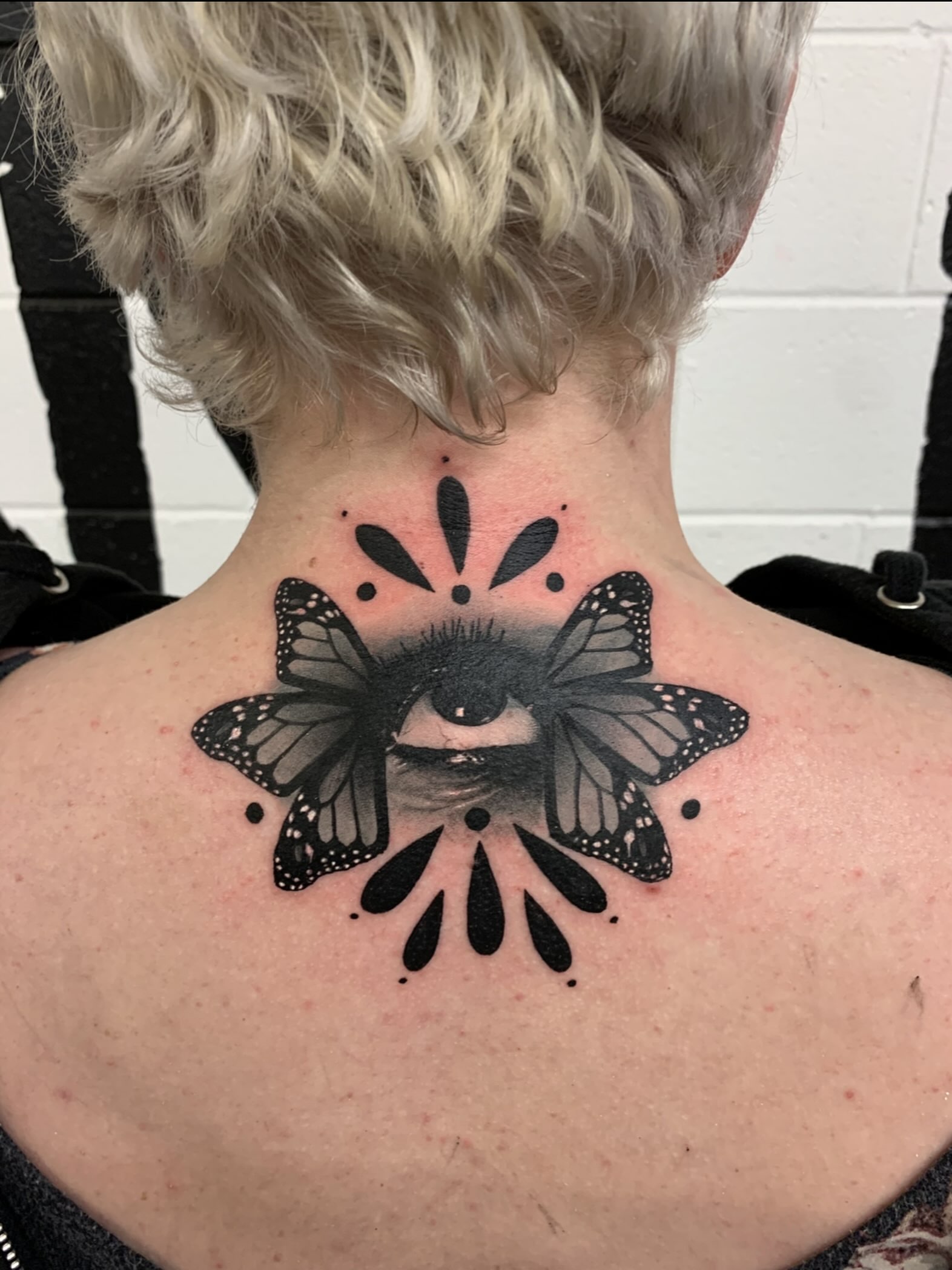 Eye and butterfly dotwork tattoo on the neck by @lil_stinker_5000, Portland, Oregon