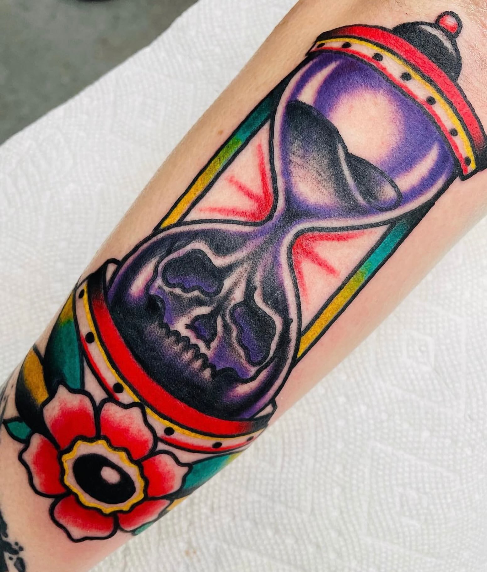 Hourglass and skull American traditional tattoo on the forearm by dave rash