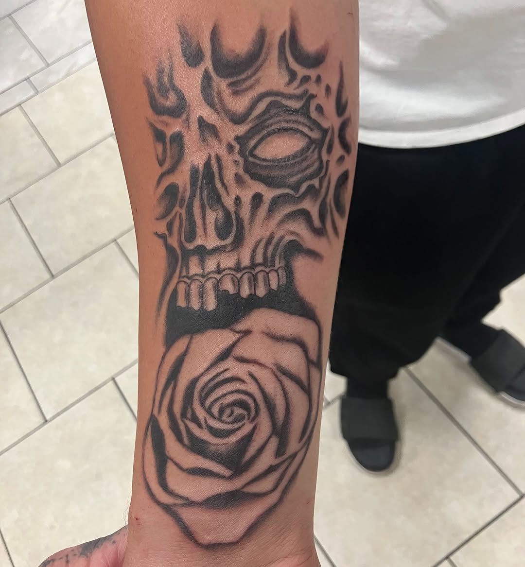 Skull and rose realism tattoo on the forearm by Bryant Johnson