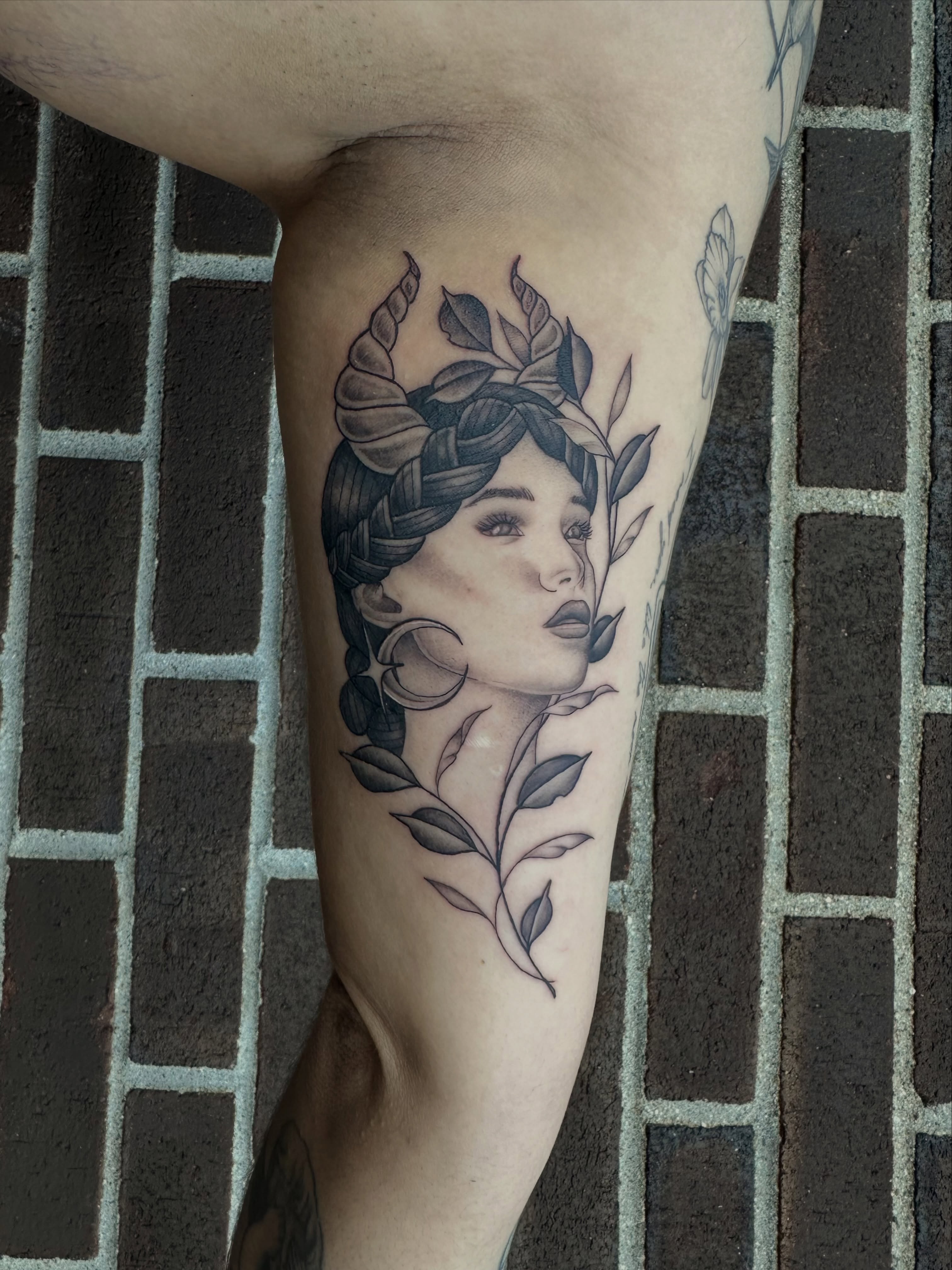 Woman with braided hair black and grey tattoo on the forearm by Hail Chaney, Somerville, Massachusetts