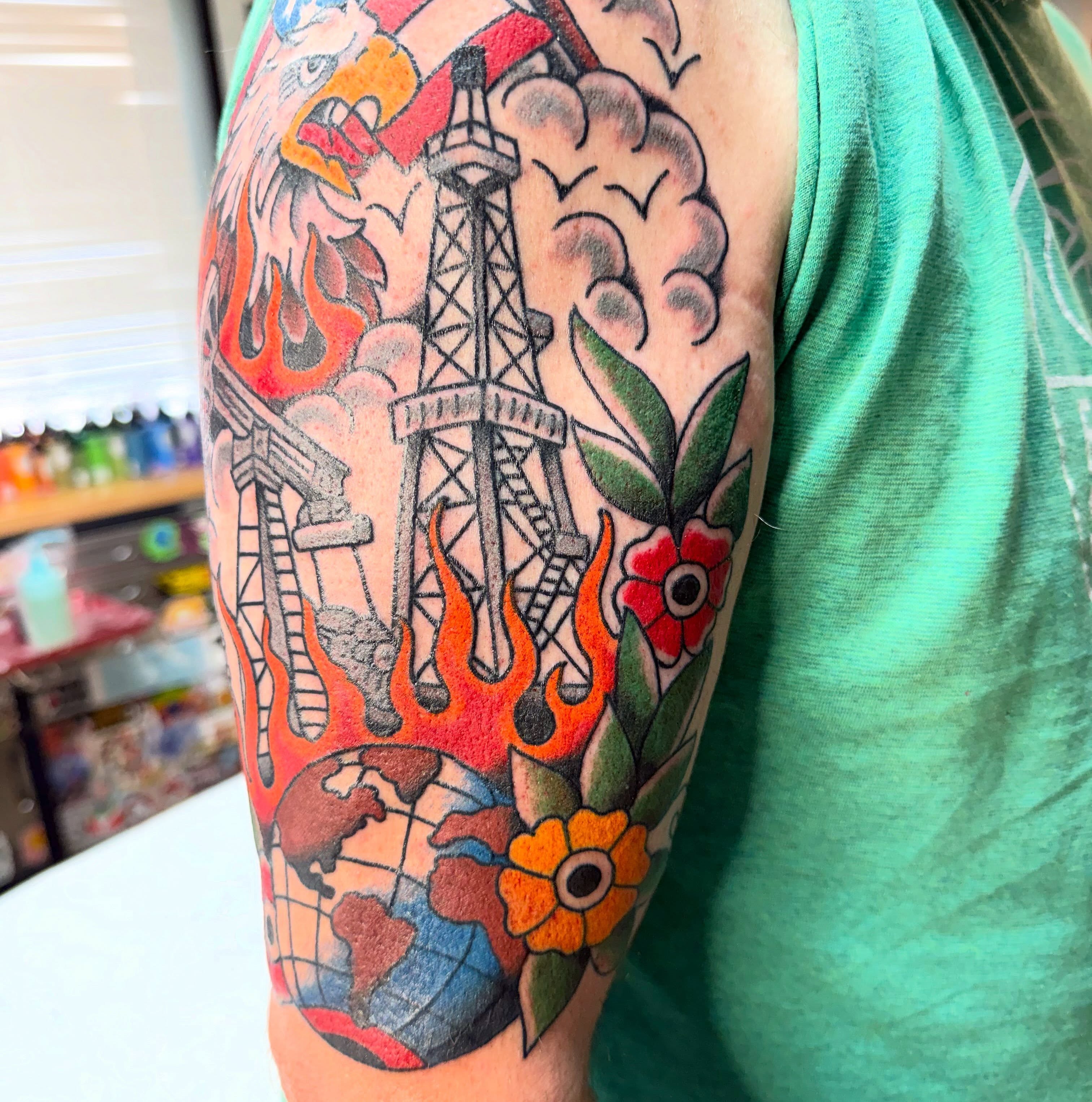 Oil rig and flames American traditional tattoo on the forearm by Spencer Coco