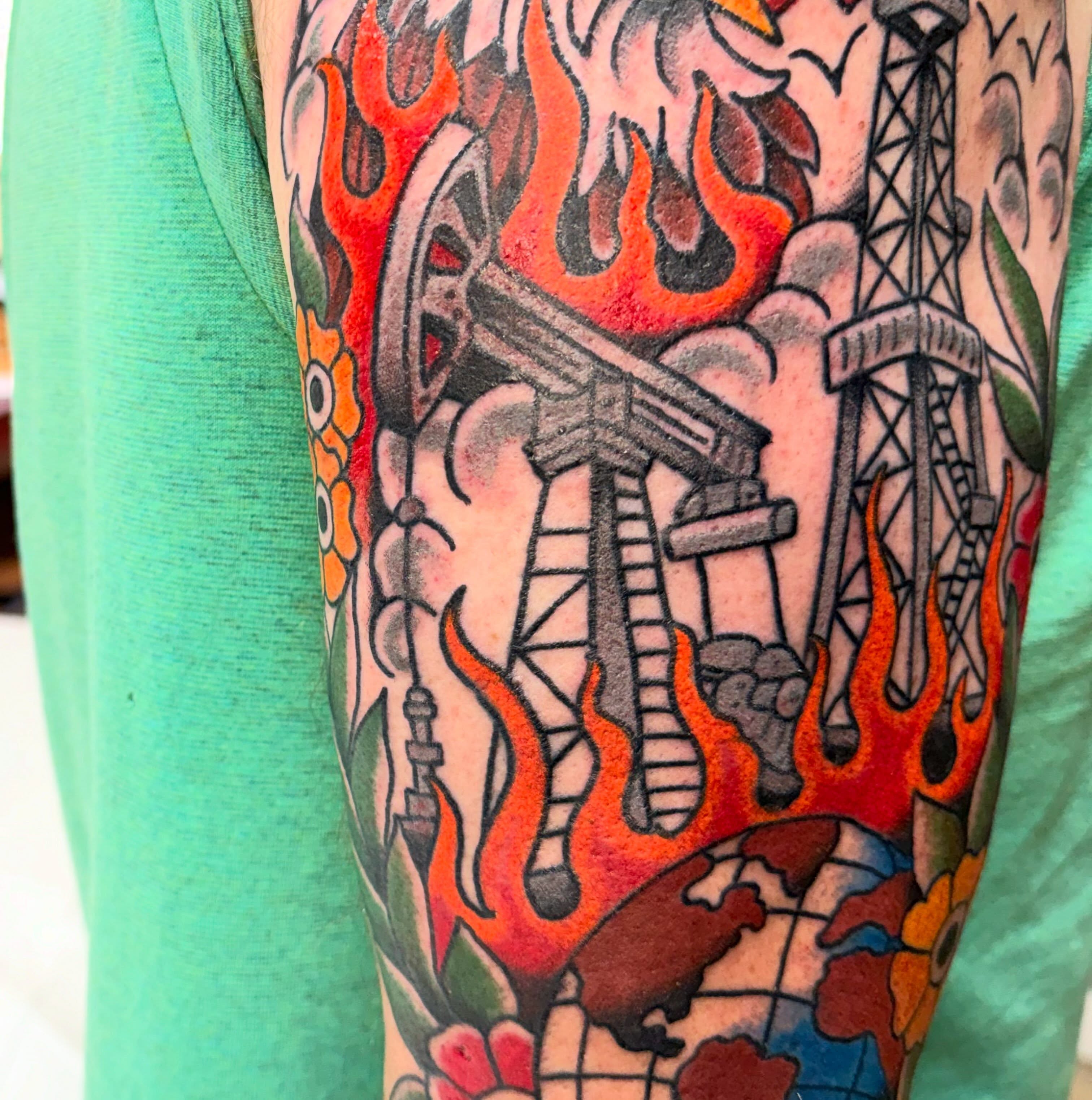 Oil rig and flames American traditional tattoo on the forearm by Spencer Coco