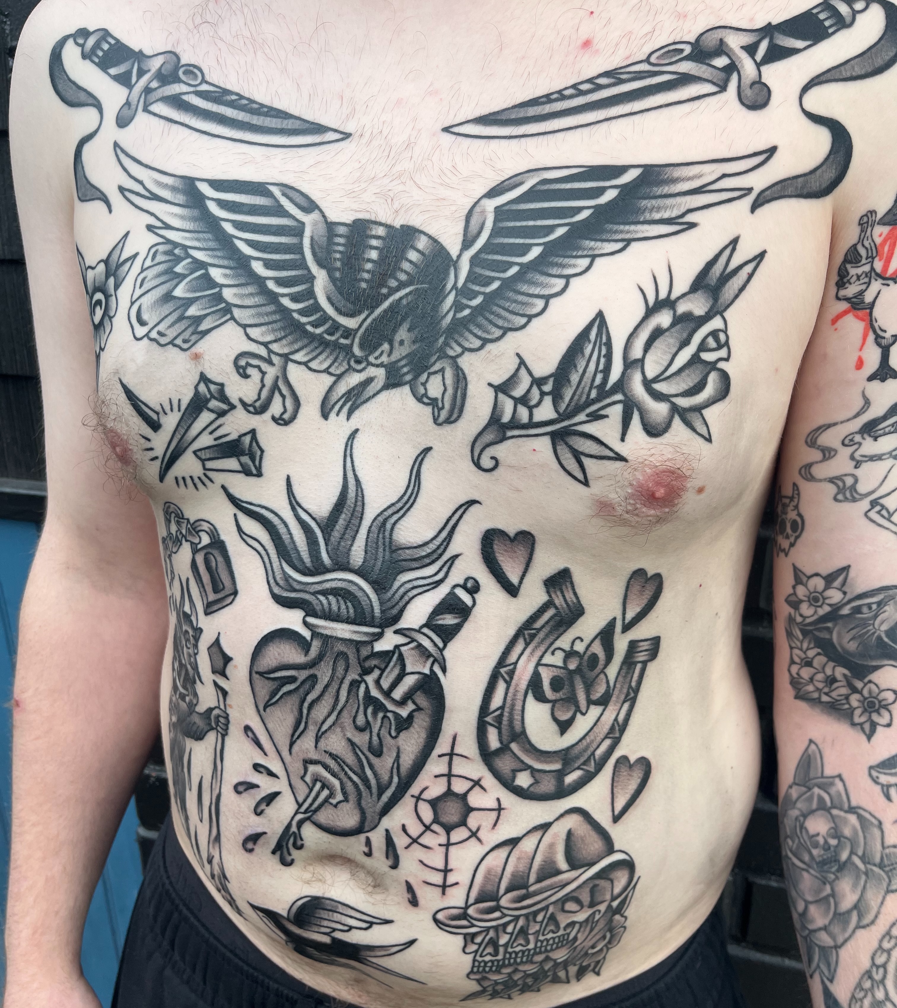 Heart with wings American traditional tattoo on the chest by August B., Renton, Washington
