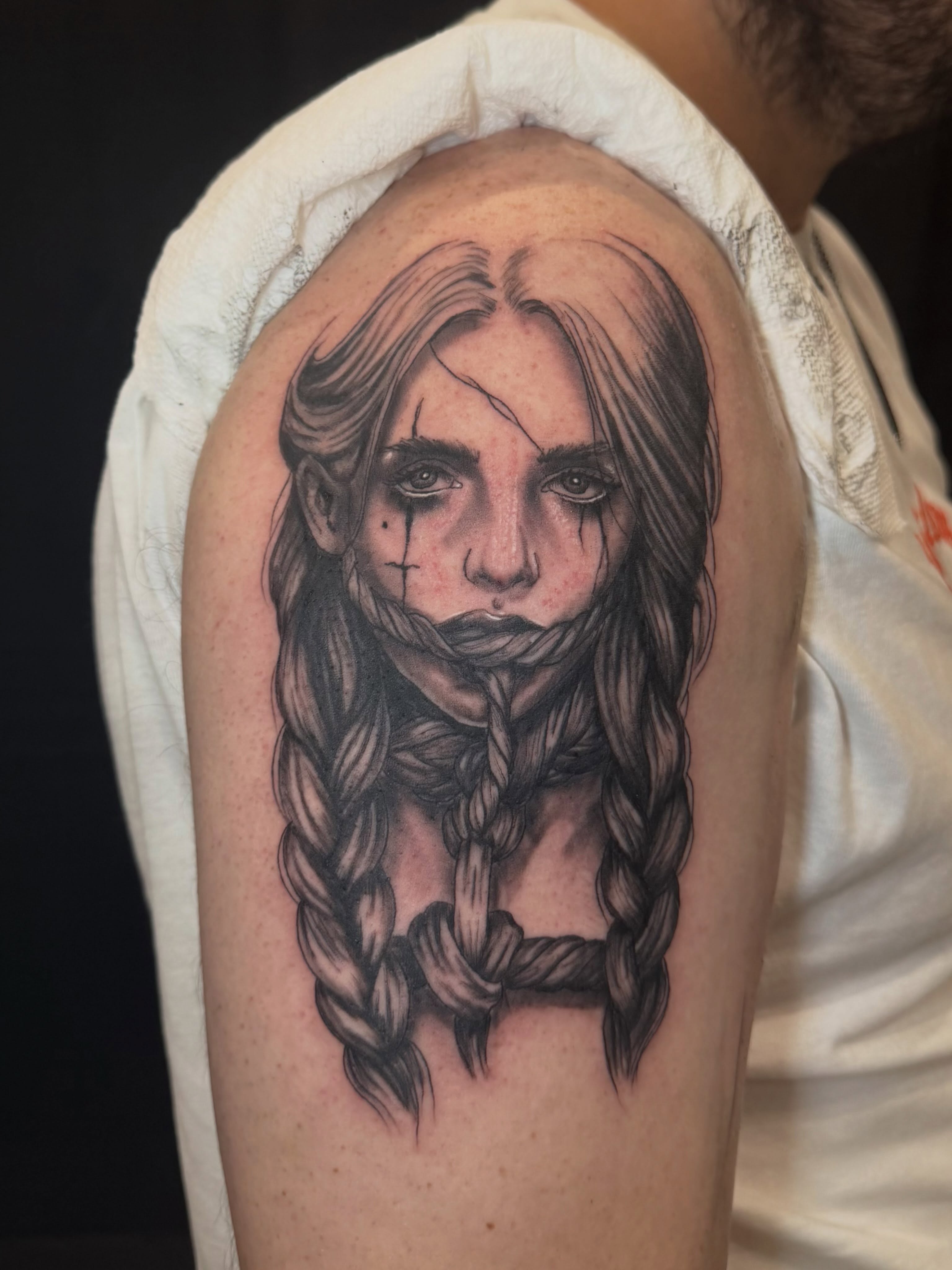Girl with braids realism tattoo on the shoulder by Zeninkz