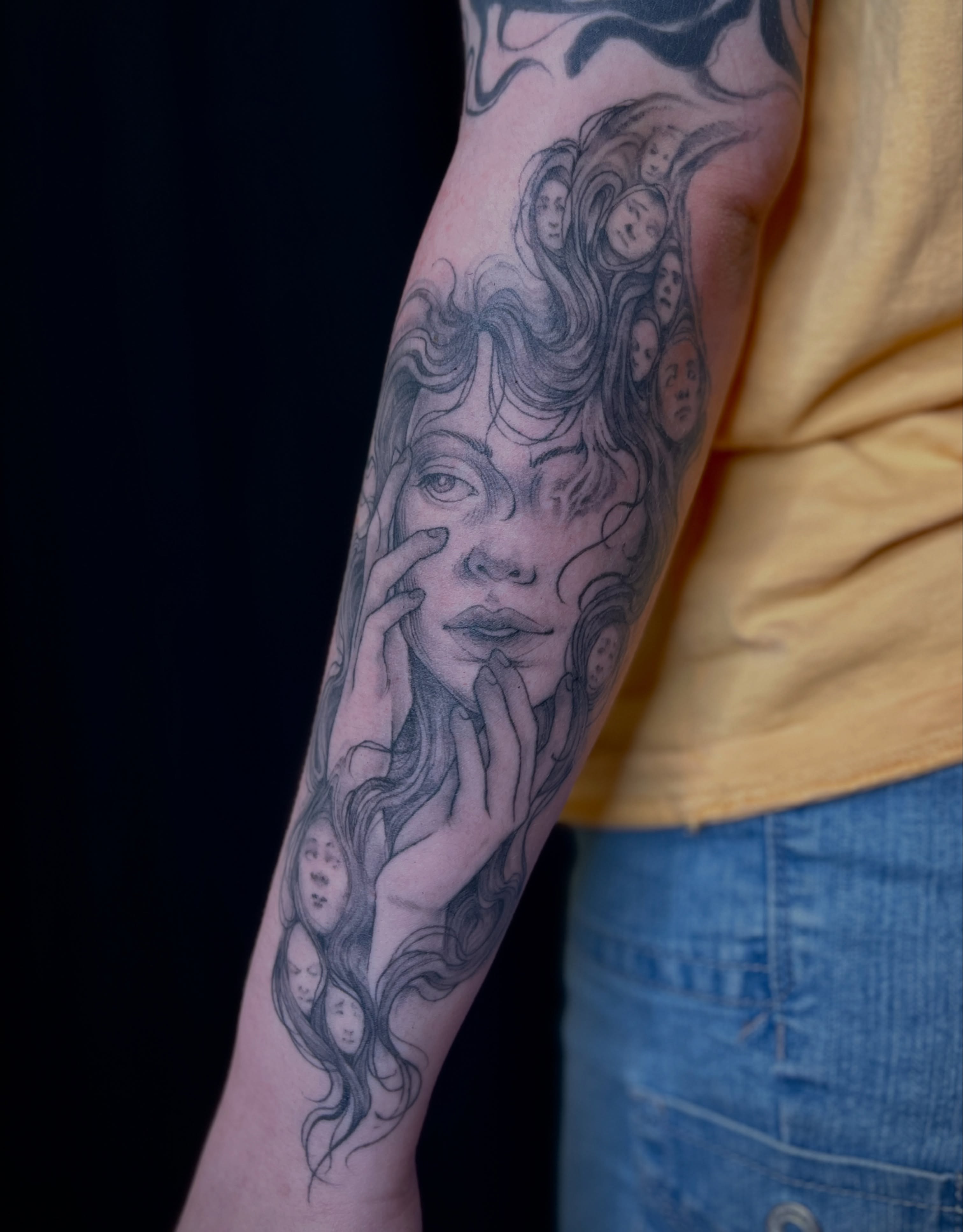 Woman with faces realism tattoo on the forearm by BELLIE ✧ Tattoo Artist
