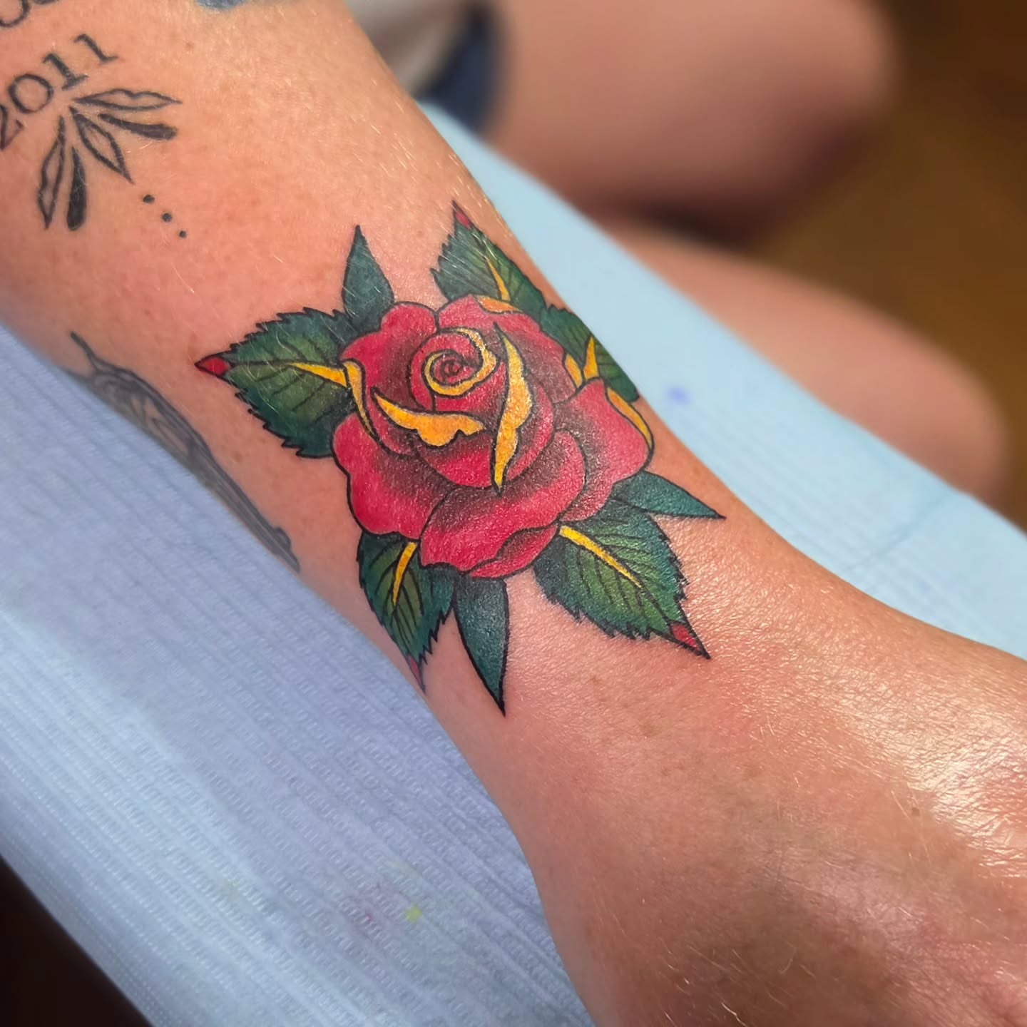 Red rose American traditional tattoo on the forearm by Jam ⚡️🐉🖤