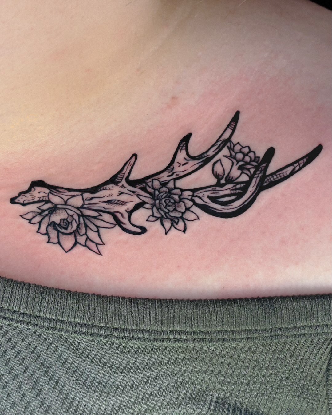 Antlers and flowers black and grey tattoo on the chest by Kal