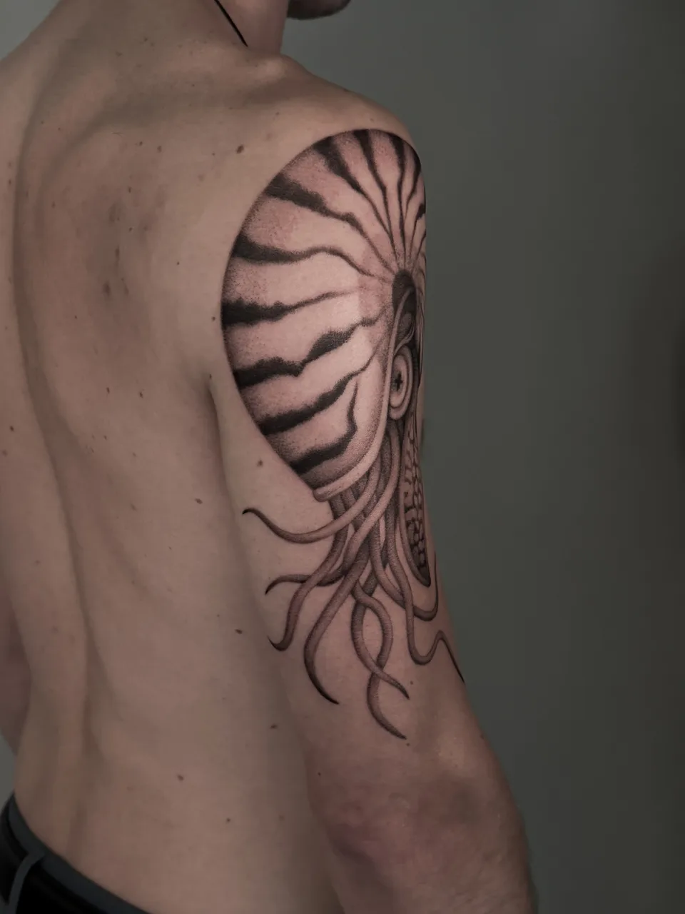 Zombie eye black and grey tattoo on the shoulder by Tattoo Artist