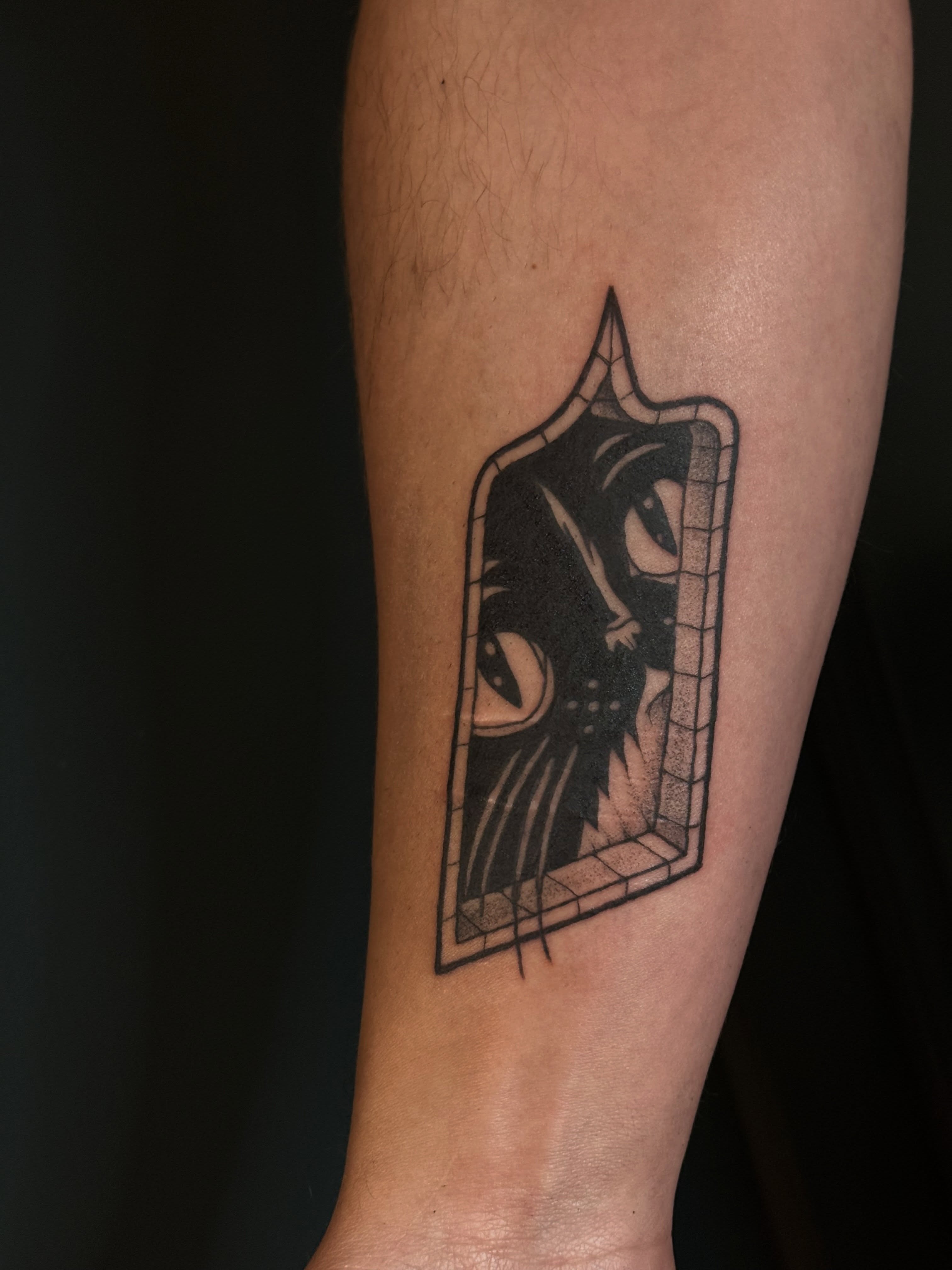 Cat in window black and grey tattoo on the forearm by Paul DeVay
