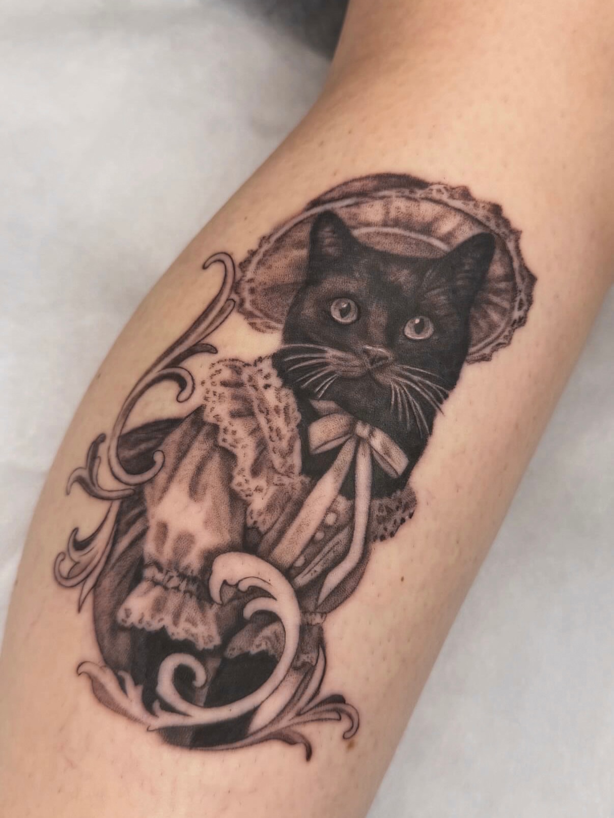 Black cat realism tattoo on the forearm by Red