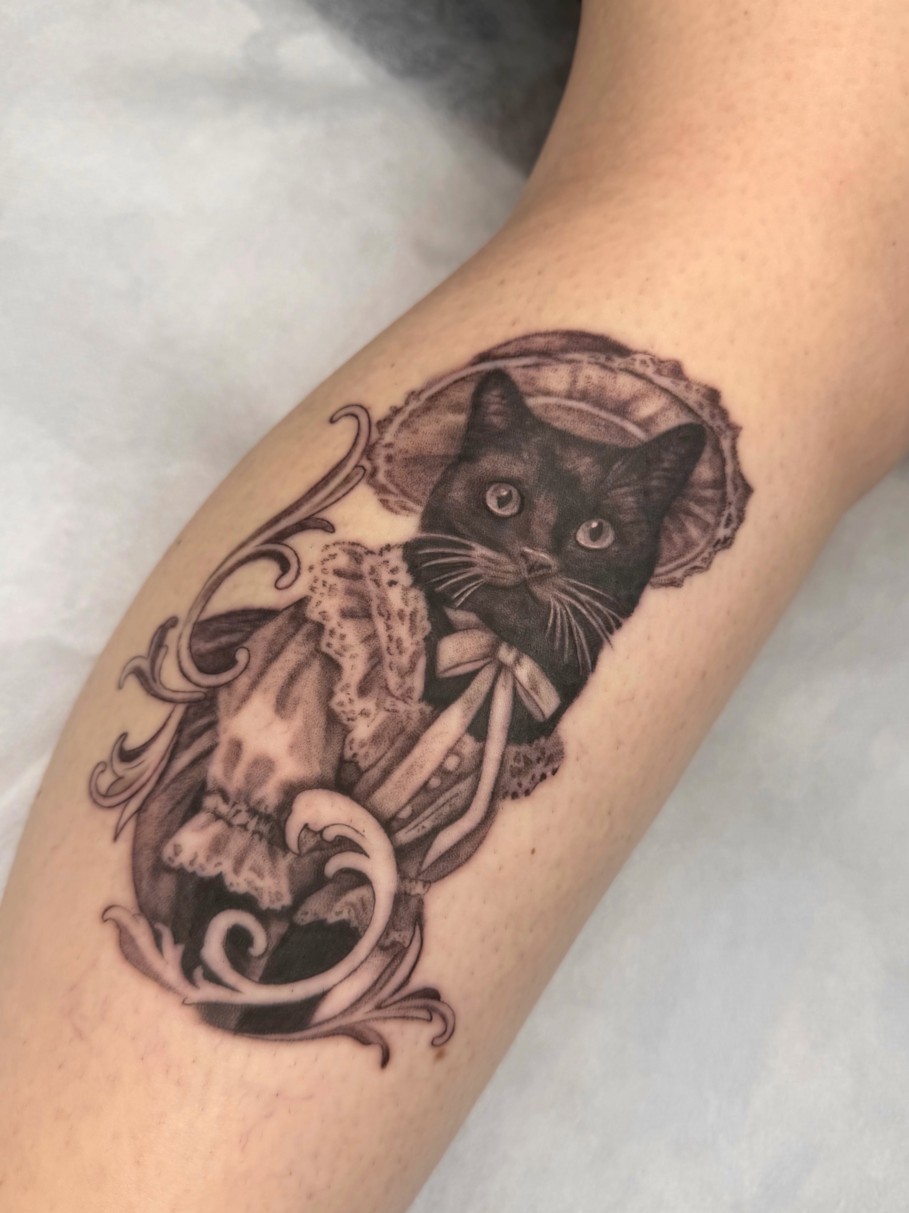 Cat in dress realism tattoo on the forearm by Red