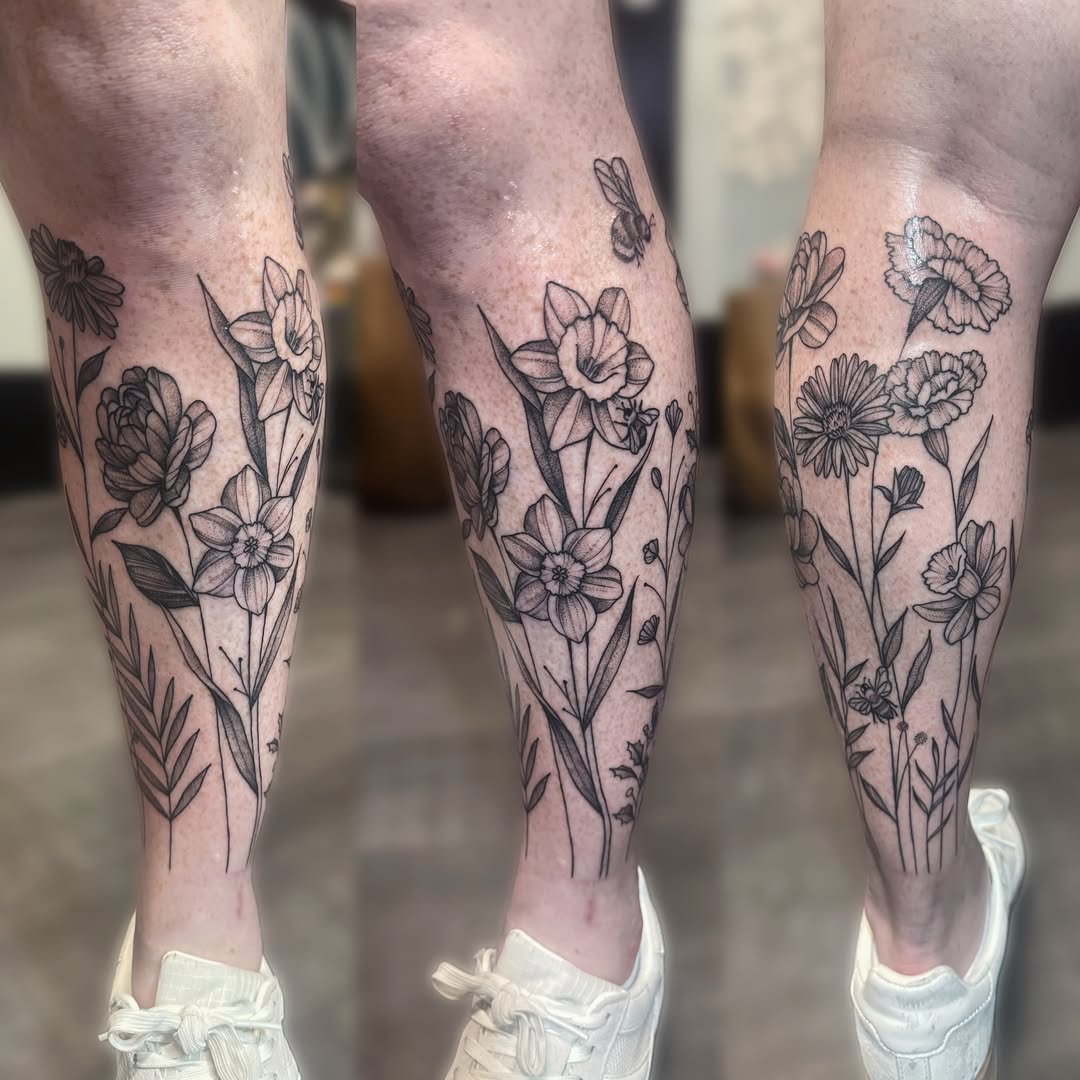 Floral arrangement black and grey tattoo on the calf by Kelsey 🖤 Tattoo Artist, Waterford Township