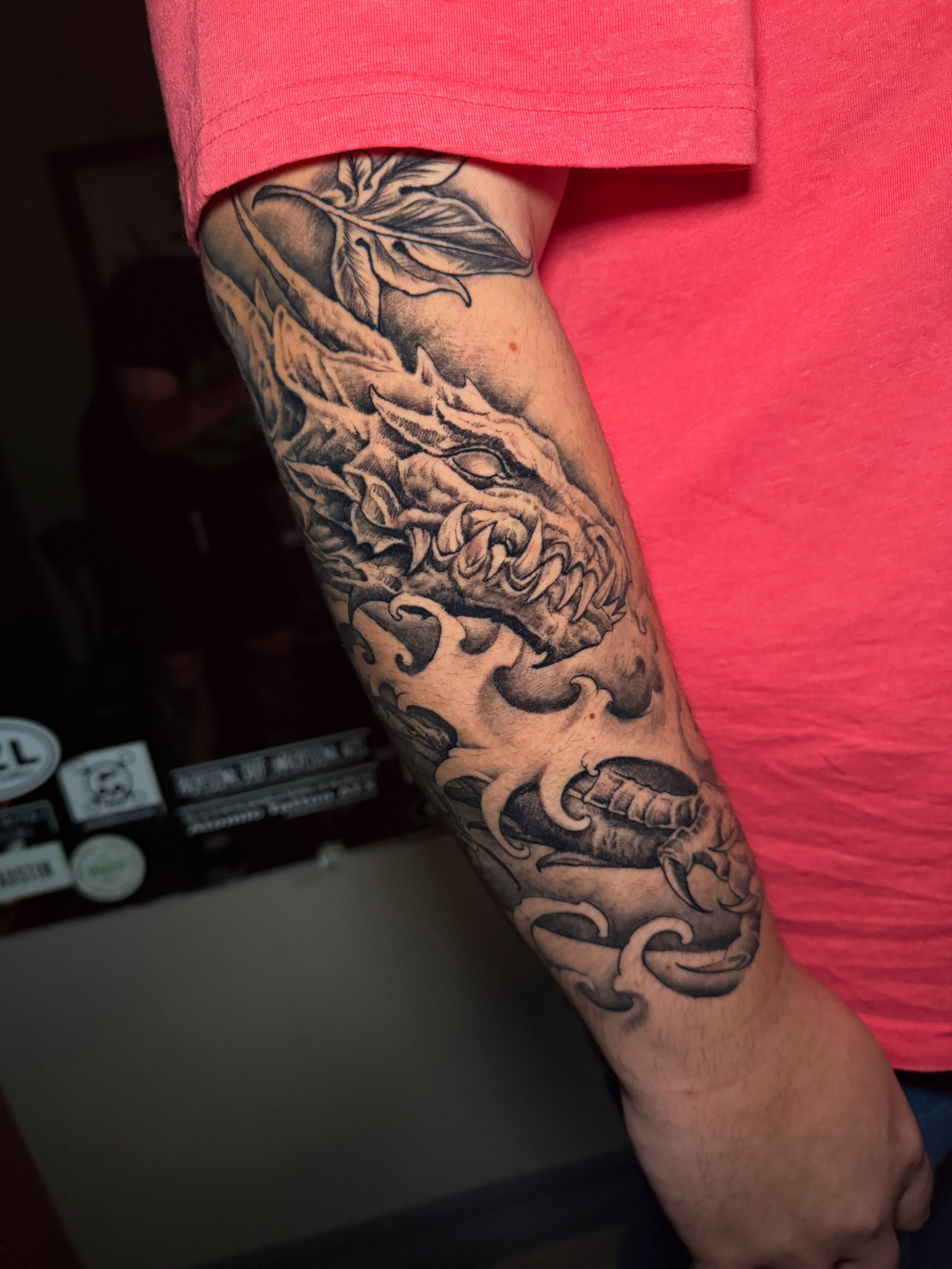 Dragon black and grey tattoo on the forearm by Adam Newton
