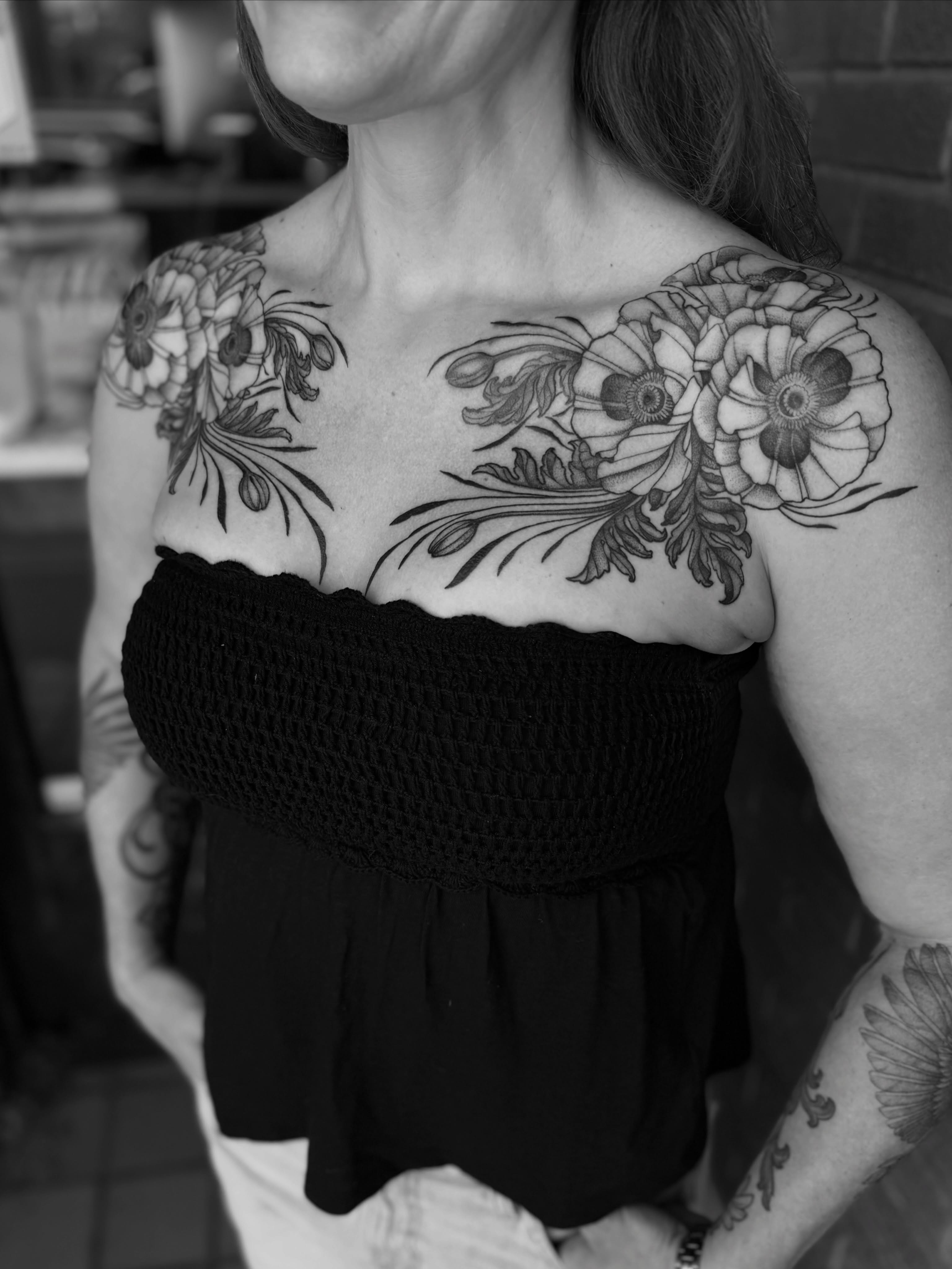Floral arrangement black and grey tattoo on the chest by Alex Brooke
