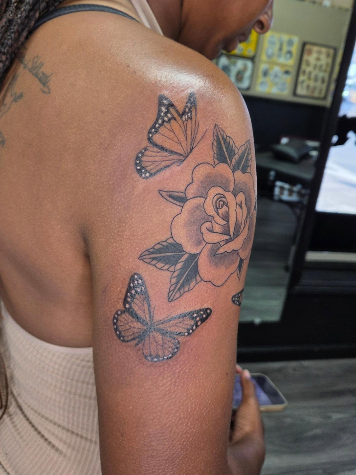 Rose and butterflies black and grey tattoo on the shoulder by Jessica Duggan