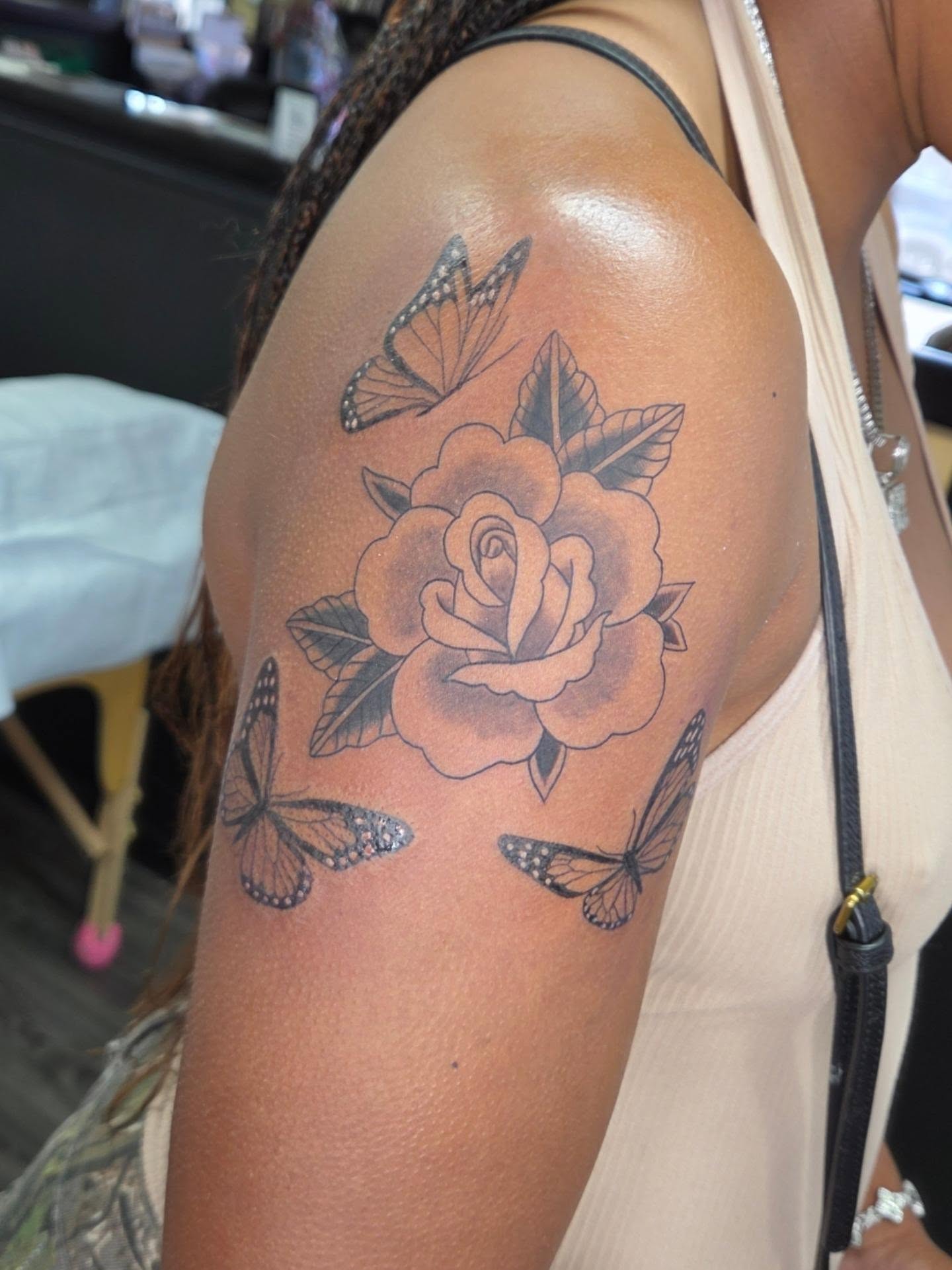 Rose and butterflies black and grey tattoo on the shoulder by Jessica Duggan