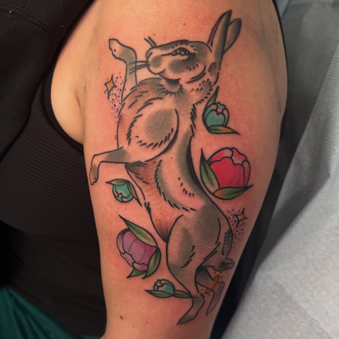 Cat and flowers American traditional tattoo on the upper arm by Kurt Brecheis Jr., Malvern, Pennsylvania