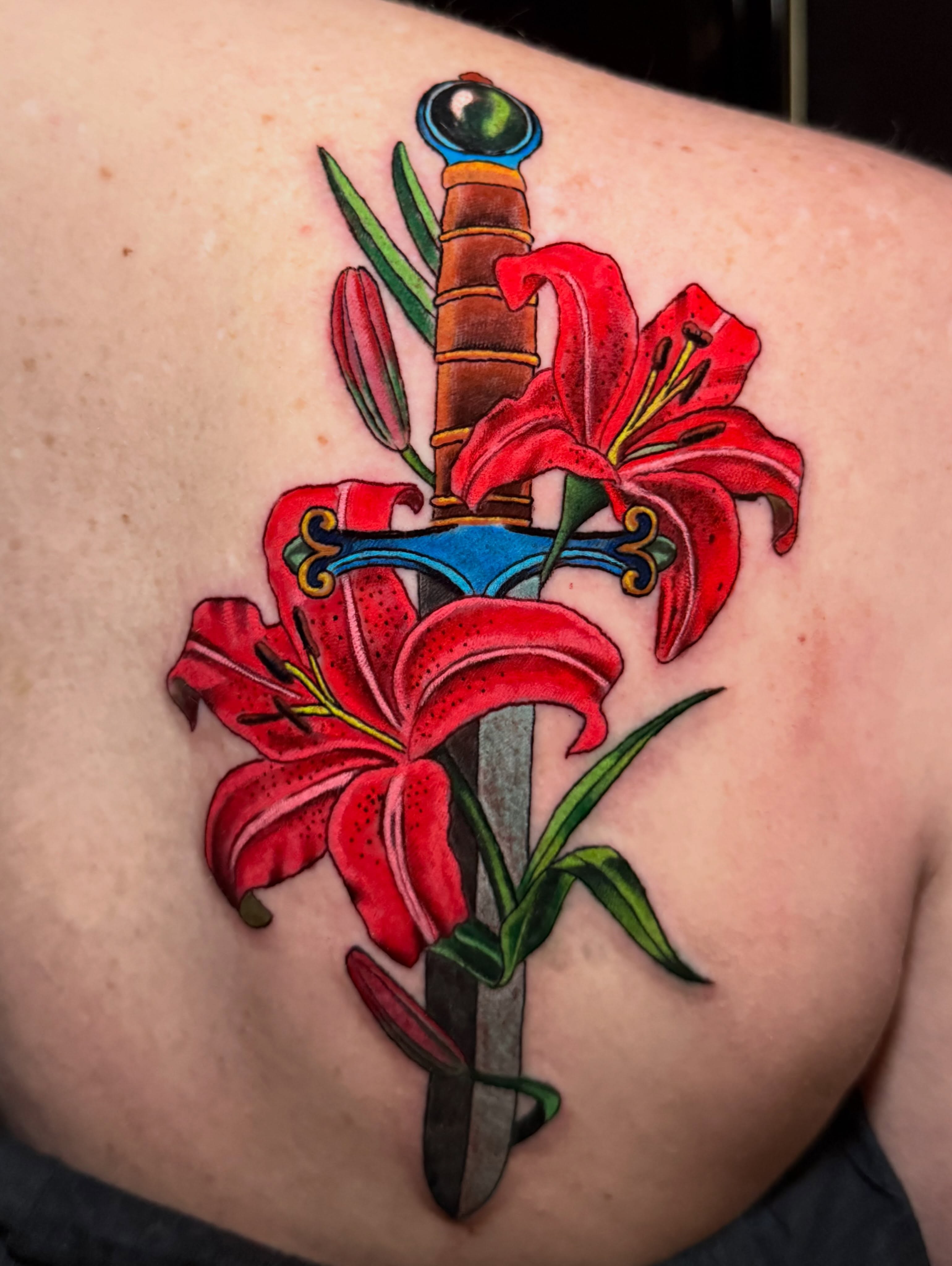 Sword and lilies American traditional tattoo on the back by Nicholas Misitano