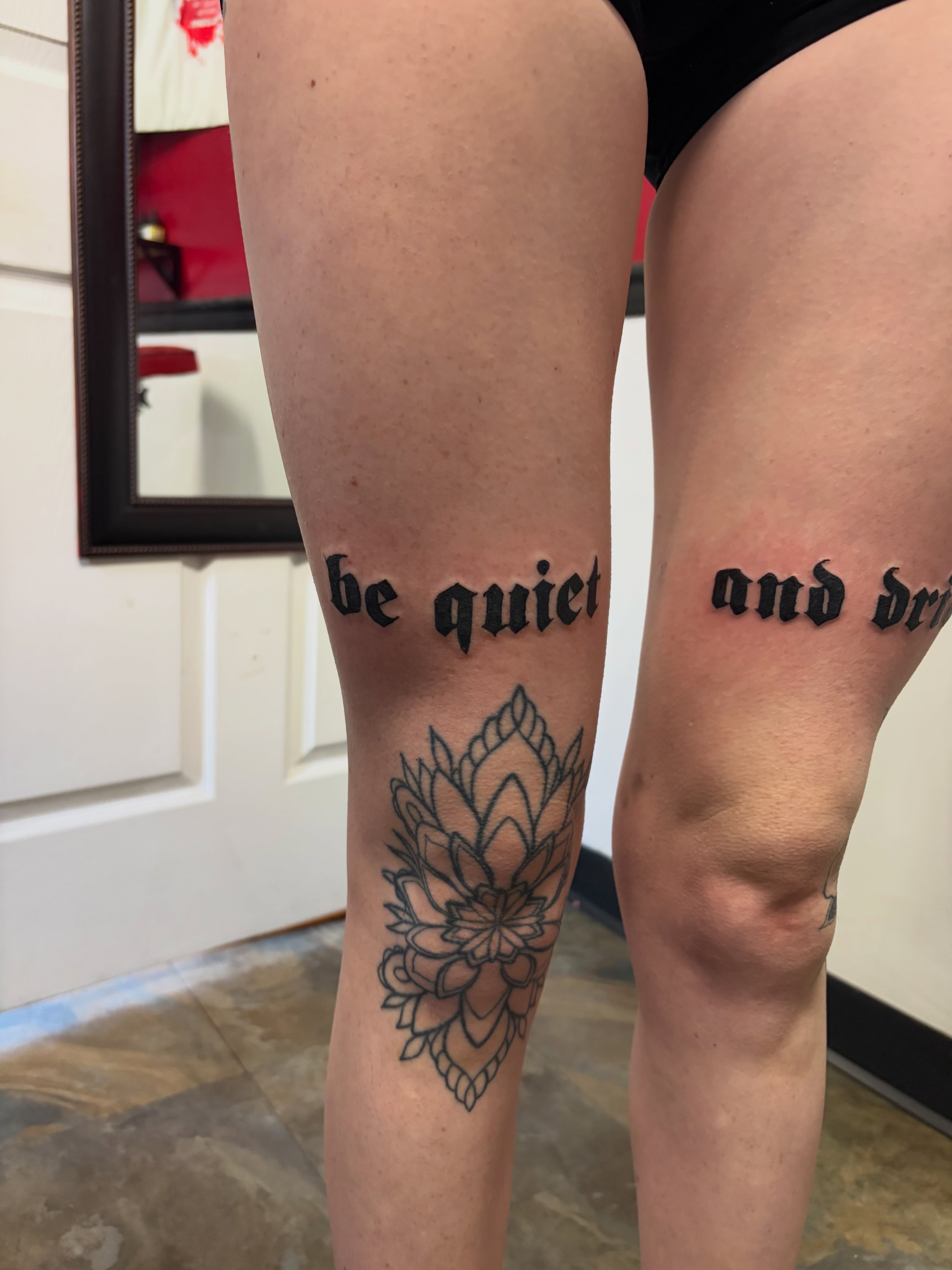 Lotus flower fine line tattoo on the leg by Vudu Tattooer